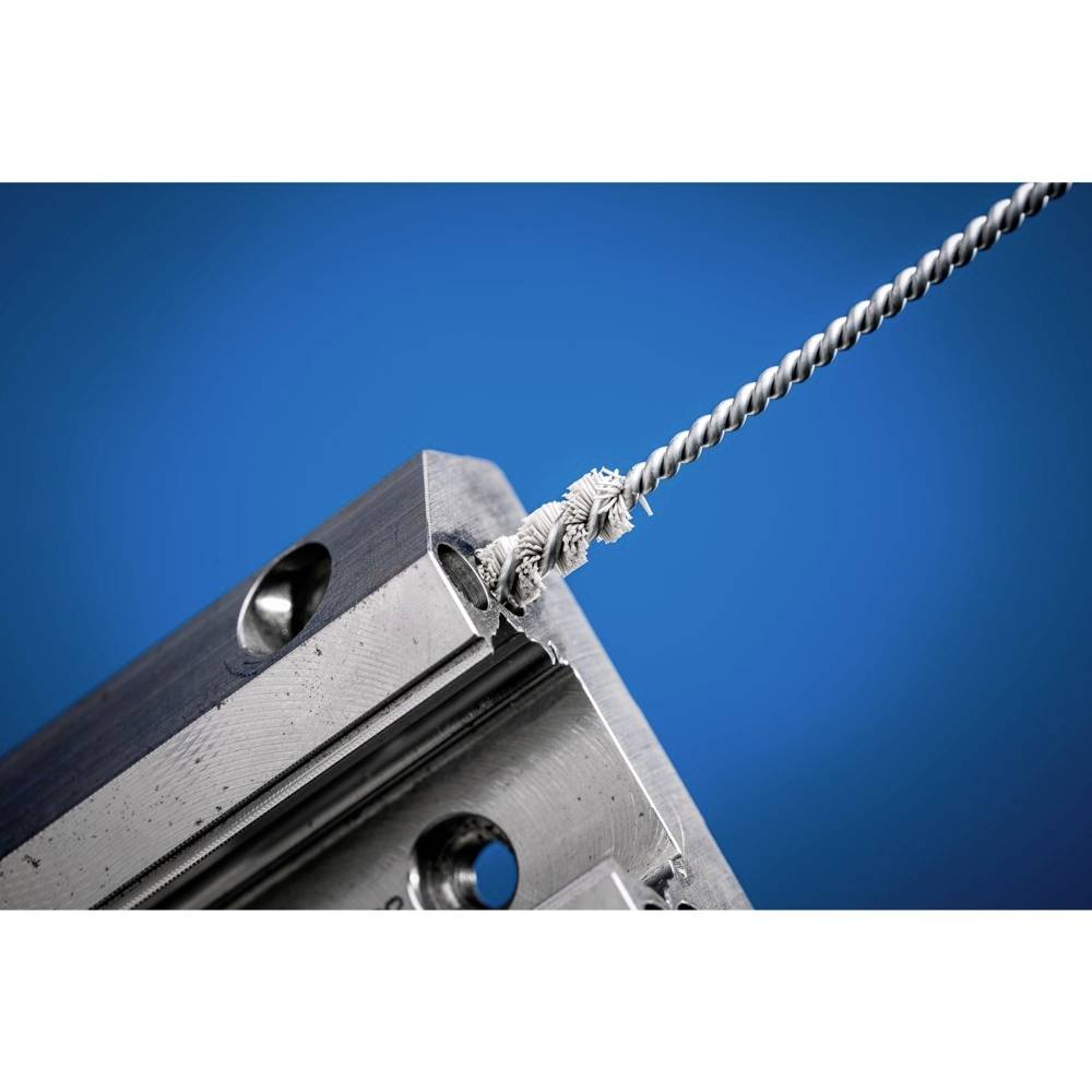 Nahaufnahme einer gezwirnten Drahtpatrone, die in einen Metallblock eingeschraubt ist, vor blauem Hintergrund.