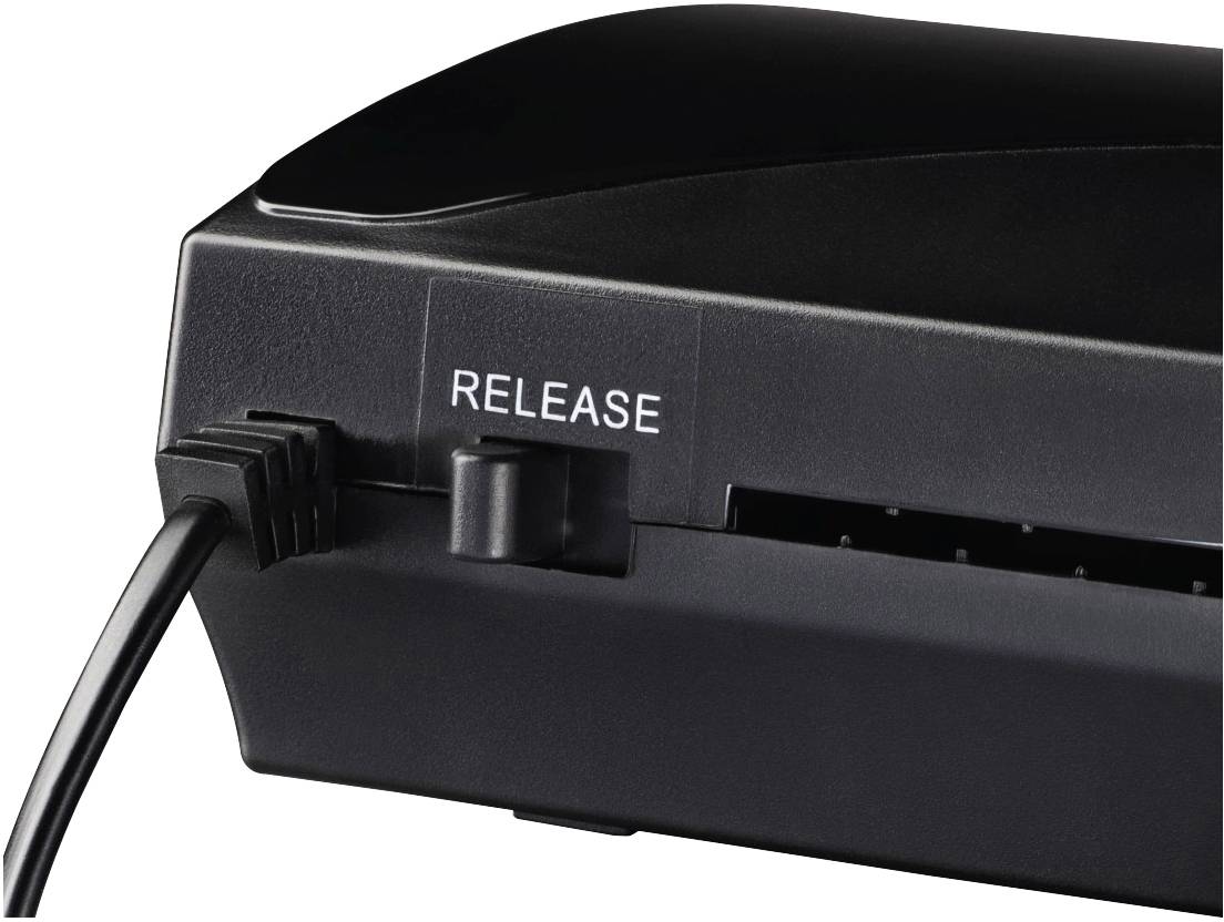 Ein schwarzes Gerät mit einem Knopf, neben dem 'RELEASE' steht. Ein Kabel ist links eingesteckt, deutet auf Anschlussoption hin.
