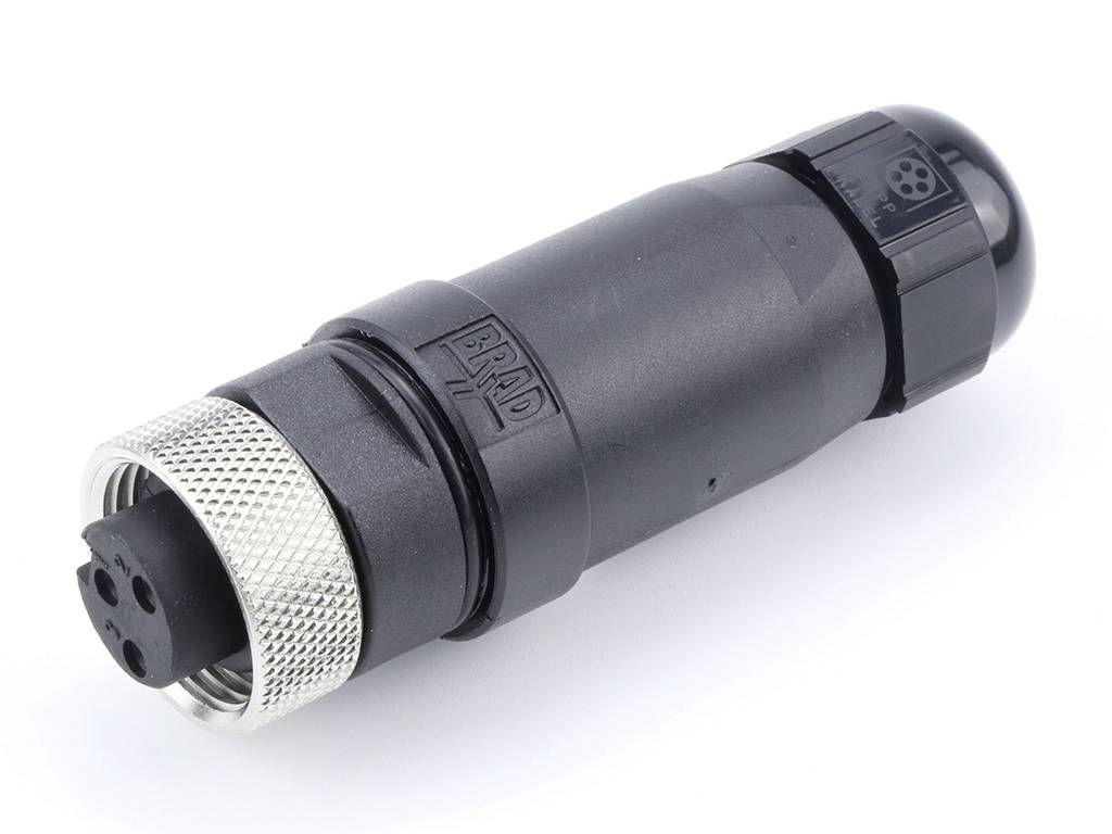 Ein schwarzer, zylindrischer Stecker mit vier Anschlüssen und einem geriffelten Metallteil zur Befestigung.