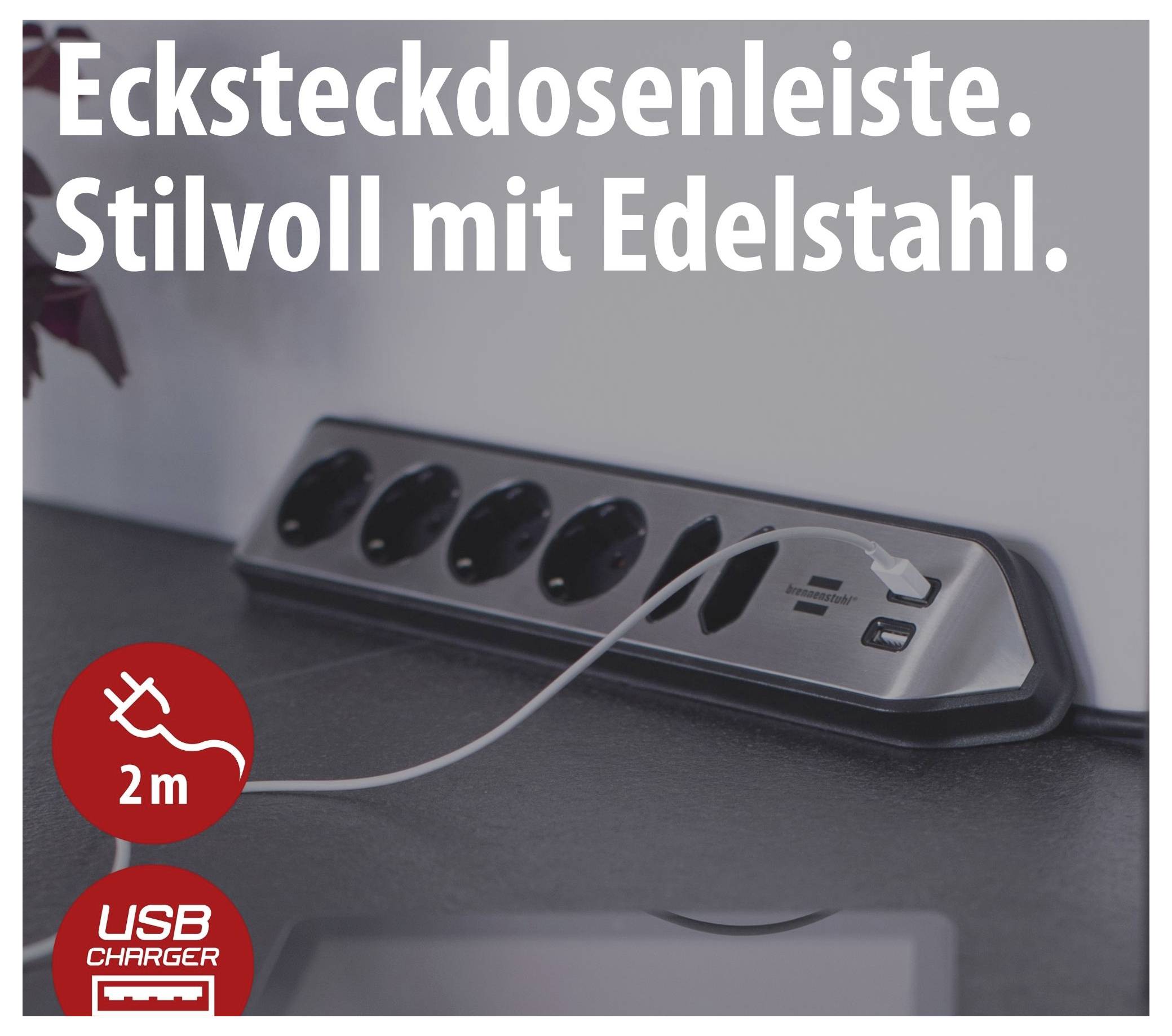 Ecksteckdosenleiste aus Edelstahl mit 2-m-Kabel und USB-Ladeanschluss; Produktfoto mit den Aufschriften 'Ecksteckdosenleiste. Stilvoll mit Edelstahl.' und '2 m' sowie 'USB CHARGER'.