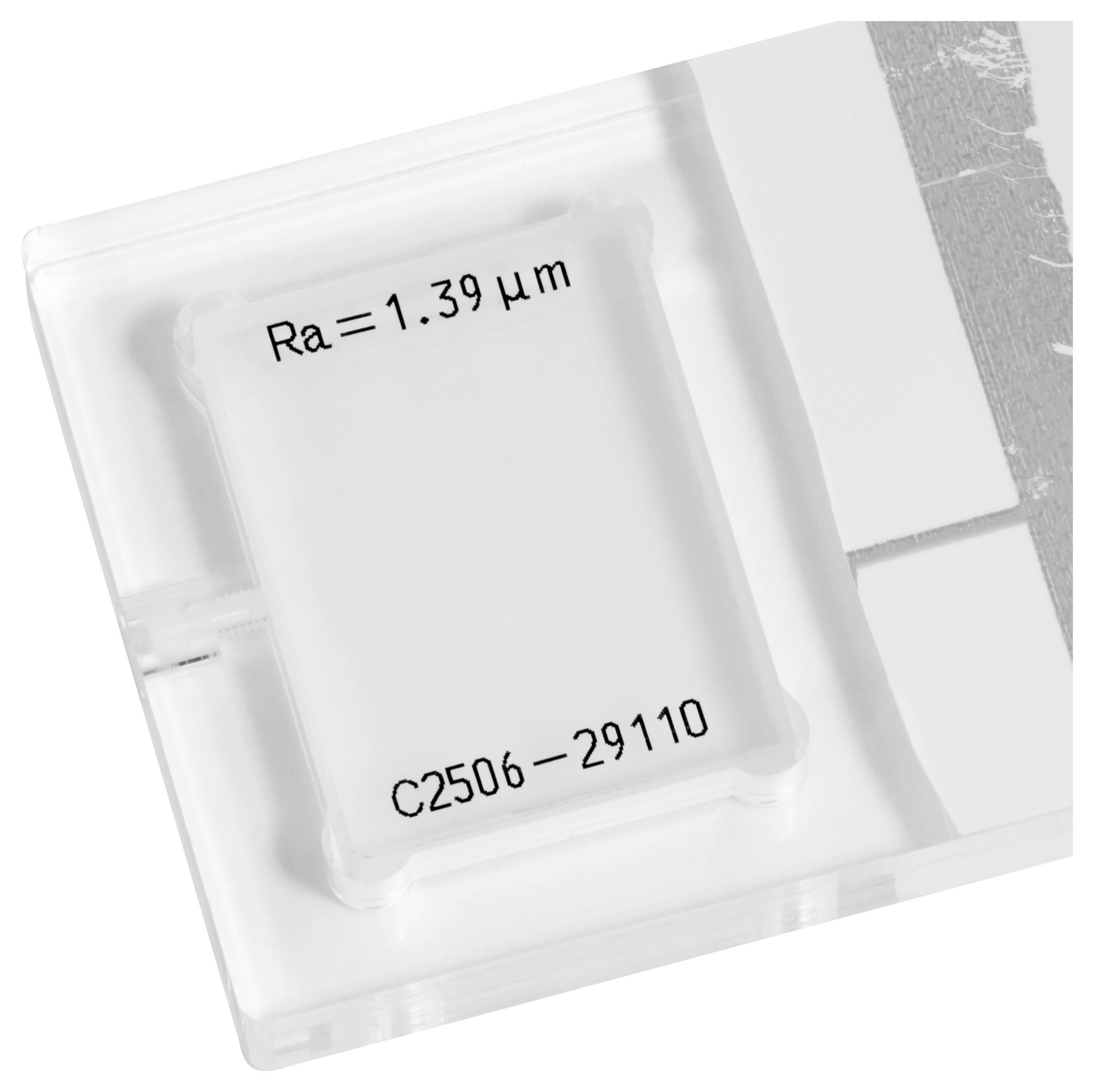 Nahaufnahme eines durchsichtigen Kunststoffpakets mit einem elektronischen Bauteil, das mit „Ra=1,39 μm
