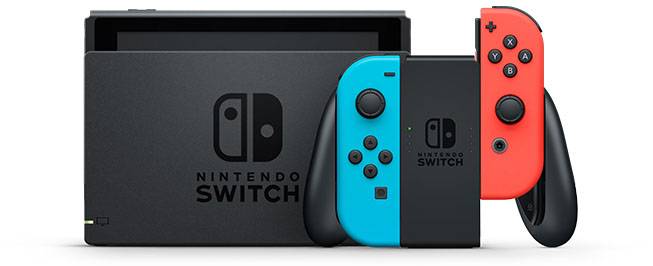 Nintendo Switch Konsole mit grauer Dockstation und zwei abnehmbaren Joy-Con-Controllern in Rot und Blau, auf weißem Hintergrund.
