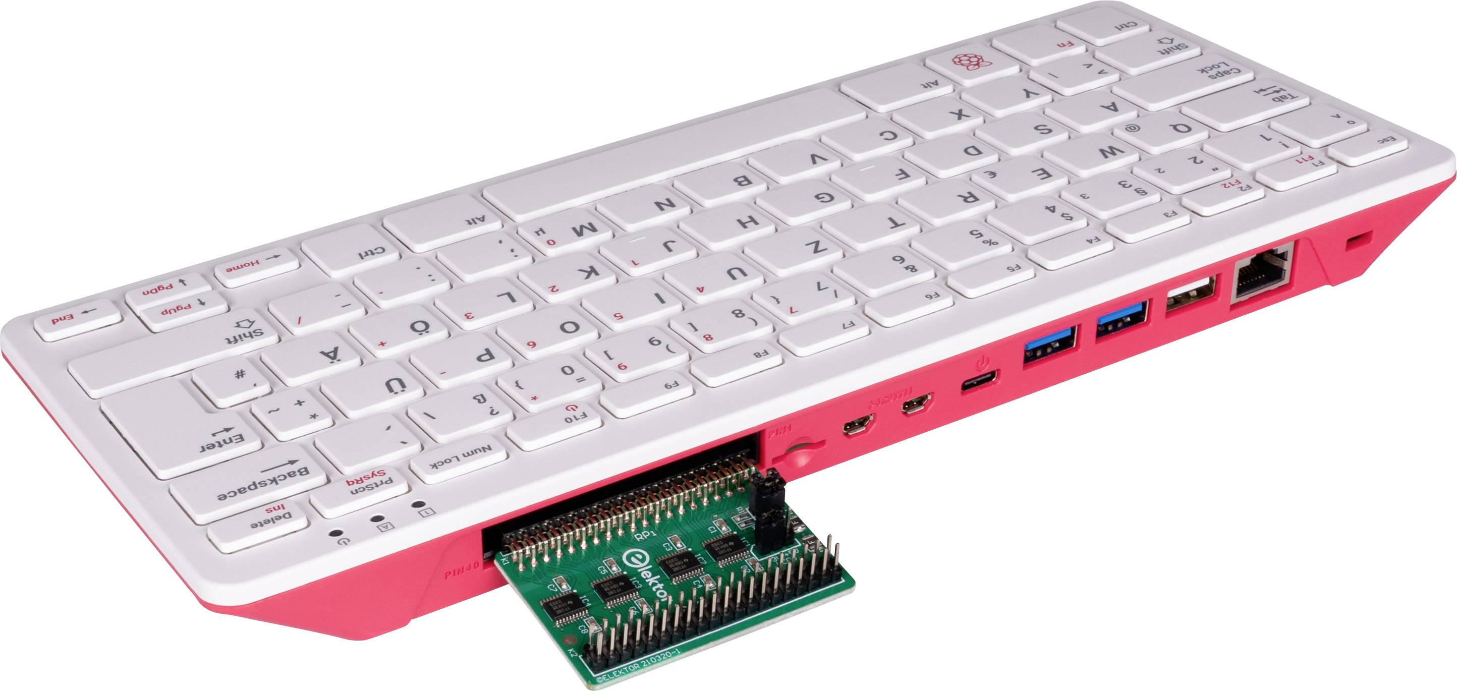 Ein kompakter Computer im Tastaturformat mit einem herausnehmbaren Modul an der Unterseite, das verschiedene Anschlüsse zeigt.
