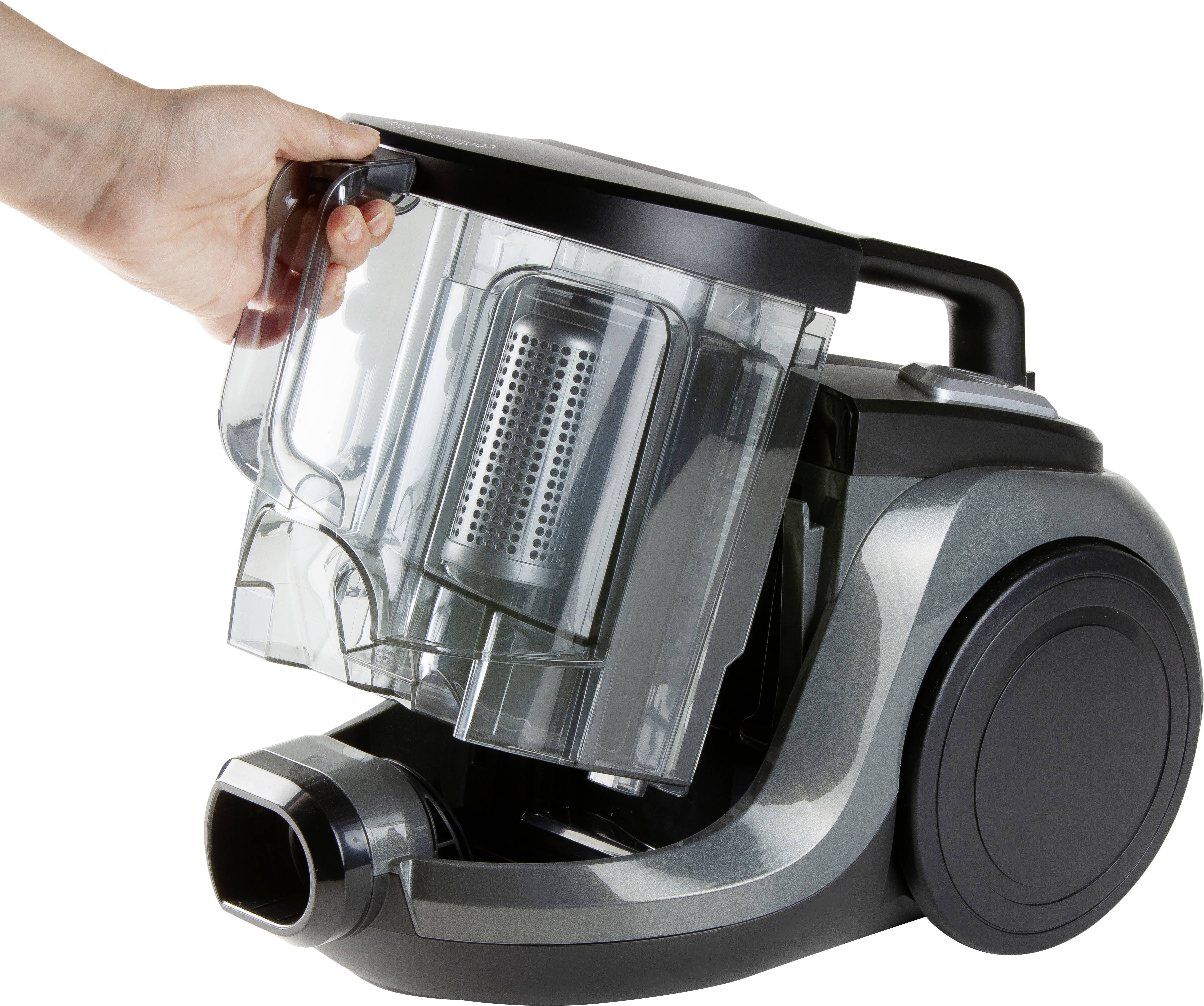 Staubsauger mit entfernbarer Staubbox, die von einer Hand gehalten wird. Hauptmerkmal ist die einfache Reinigung durch Abnehm-Funktion.