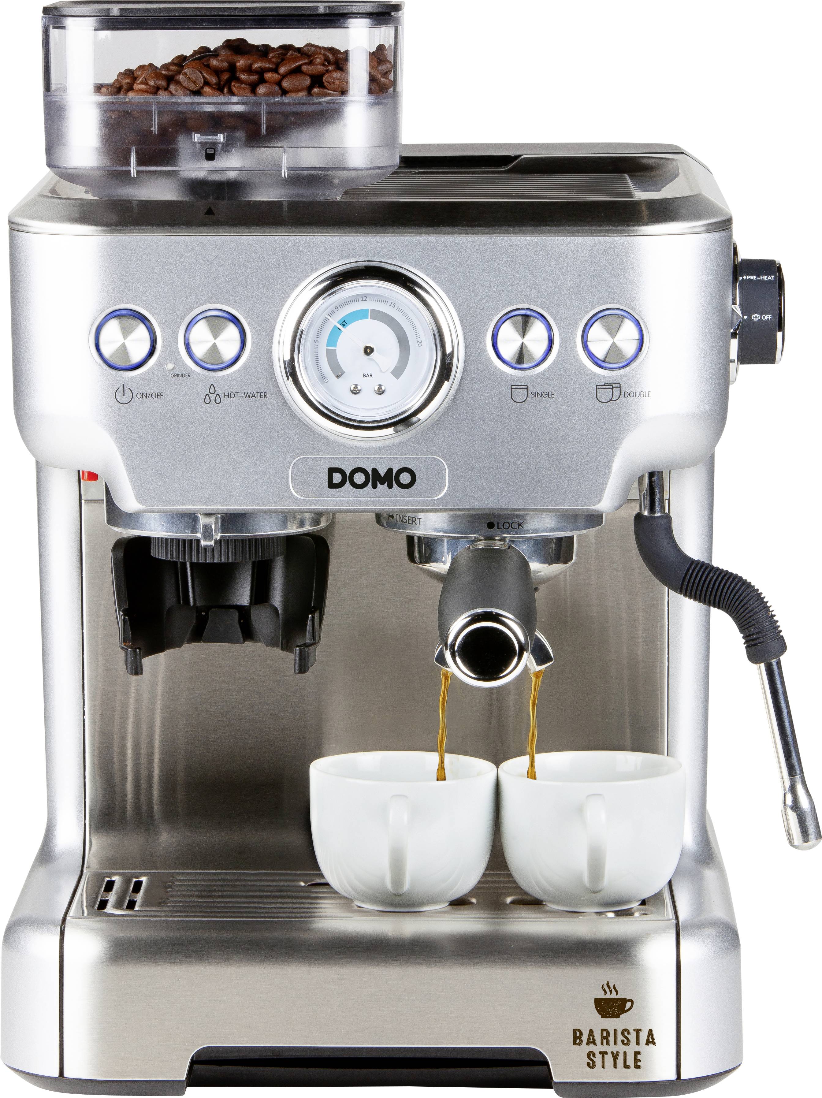 Silberne Espressomaschine mit zwei Tassen unter den Ausläufen. Kaffeebohnen sind oben sichtbar. Steuerungsknöpfe mit Symbolen.