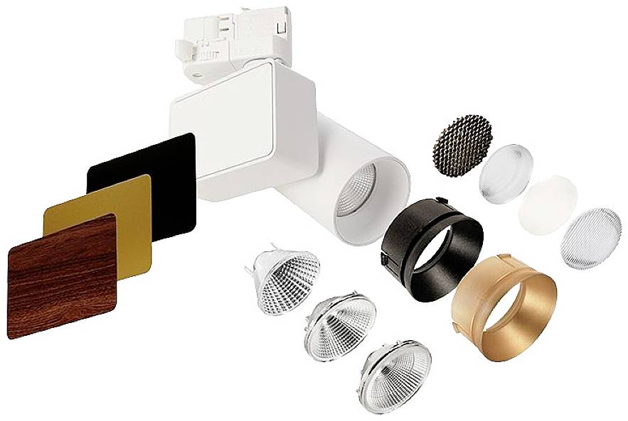 Spotleuchten mit austauschbaren Abdeckungen und Linsen in verschiedenen Farben und Materialien, darunter Holz-, Gold- und Metalloptik.