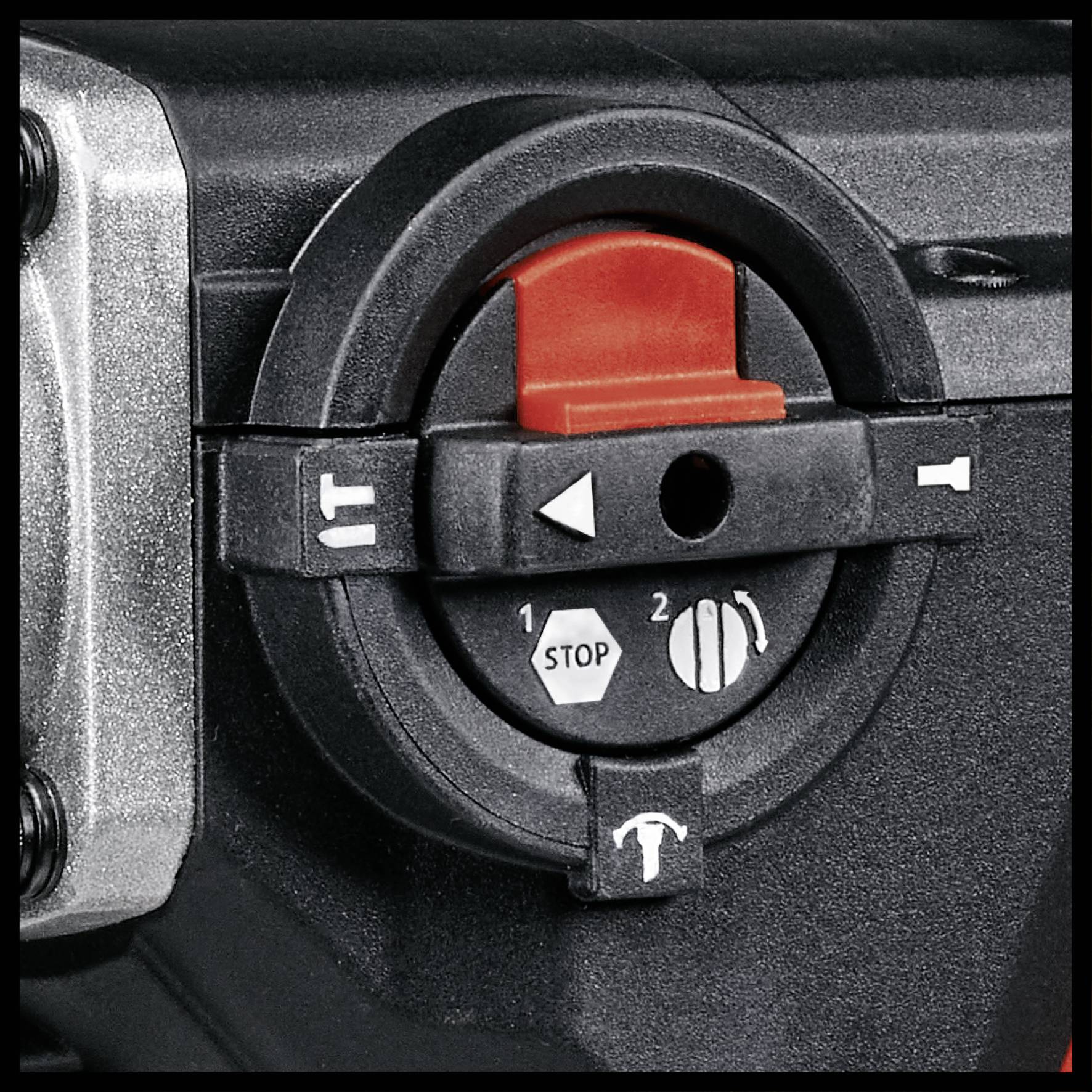 Schalter an einem Gerät mit drei Symbolen: 'Stop' oben, '1' links für niedrige Geschwindigkeit, '2' rechts für hohe Geschwindigkeit.