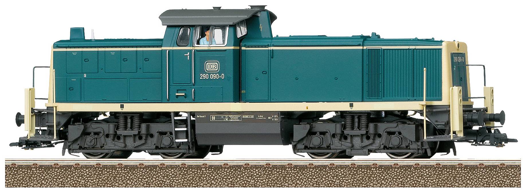Ein Modellzug im Maßstab 1:87 zeigt eine grüne und beige Diesellokomotive auf Gleisen mit detaillierter Fahrgestellansicht.