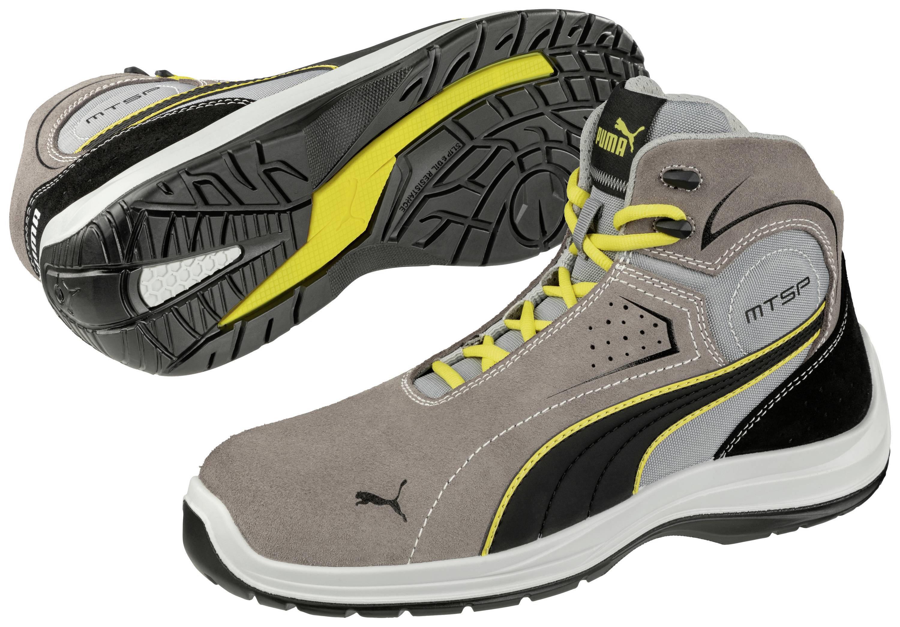 Ein Paar sportliche, graue und schwarze Puma-Stiefel mit gelben Details und rutschfester Sohle, ideal für Outdoor-Aktivitäten.