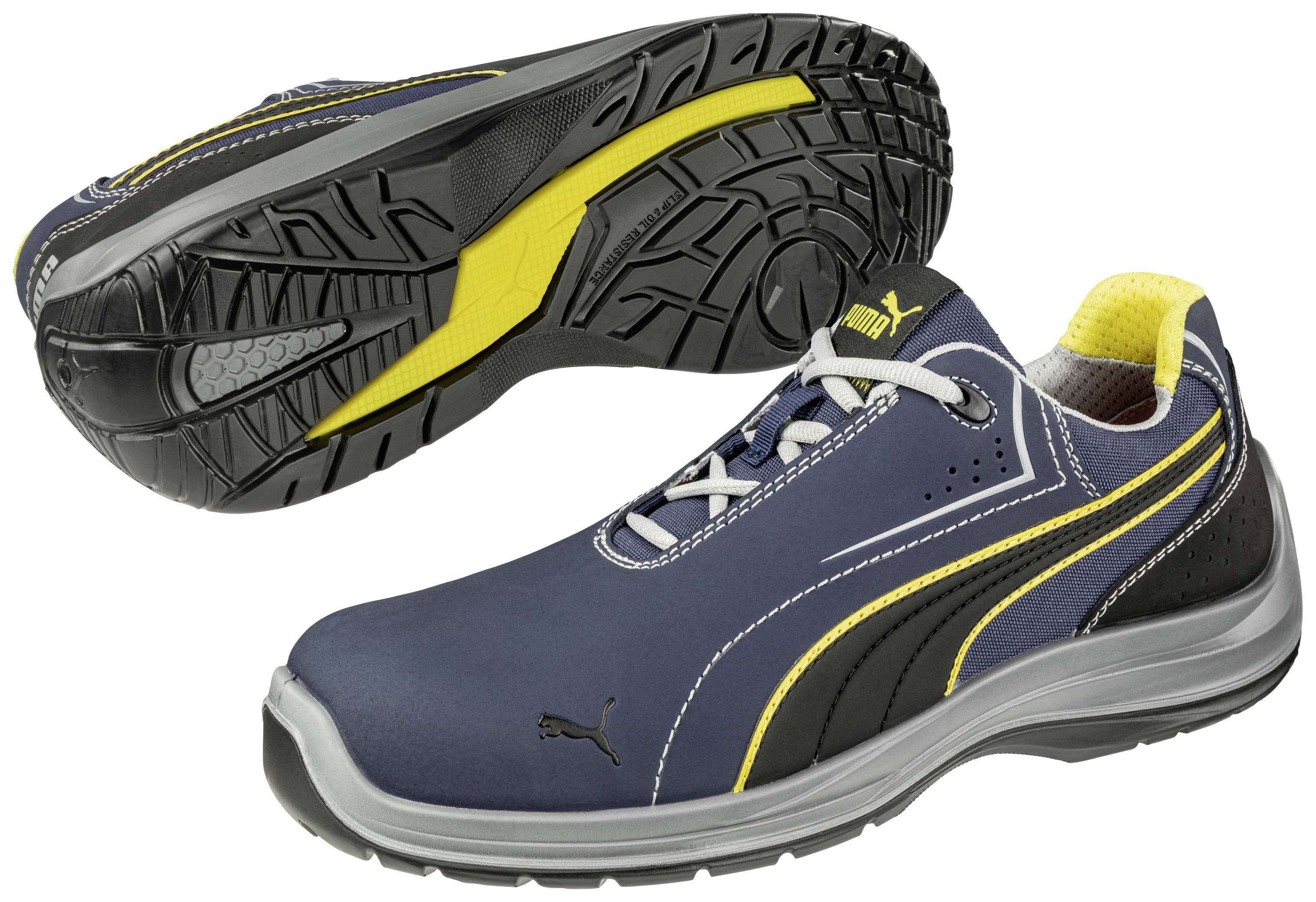 Sportschuh in Blau mit gelben und schwarzen Akzenten, zeigt Sohle mit rutschfestem Profil und Markenlogo, seitliche Ansicht.