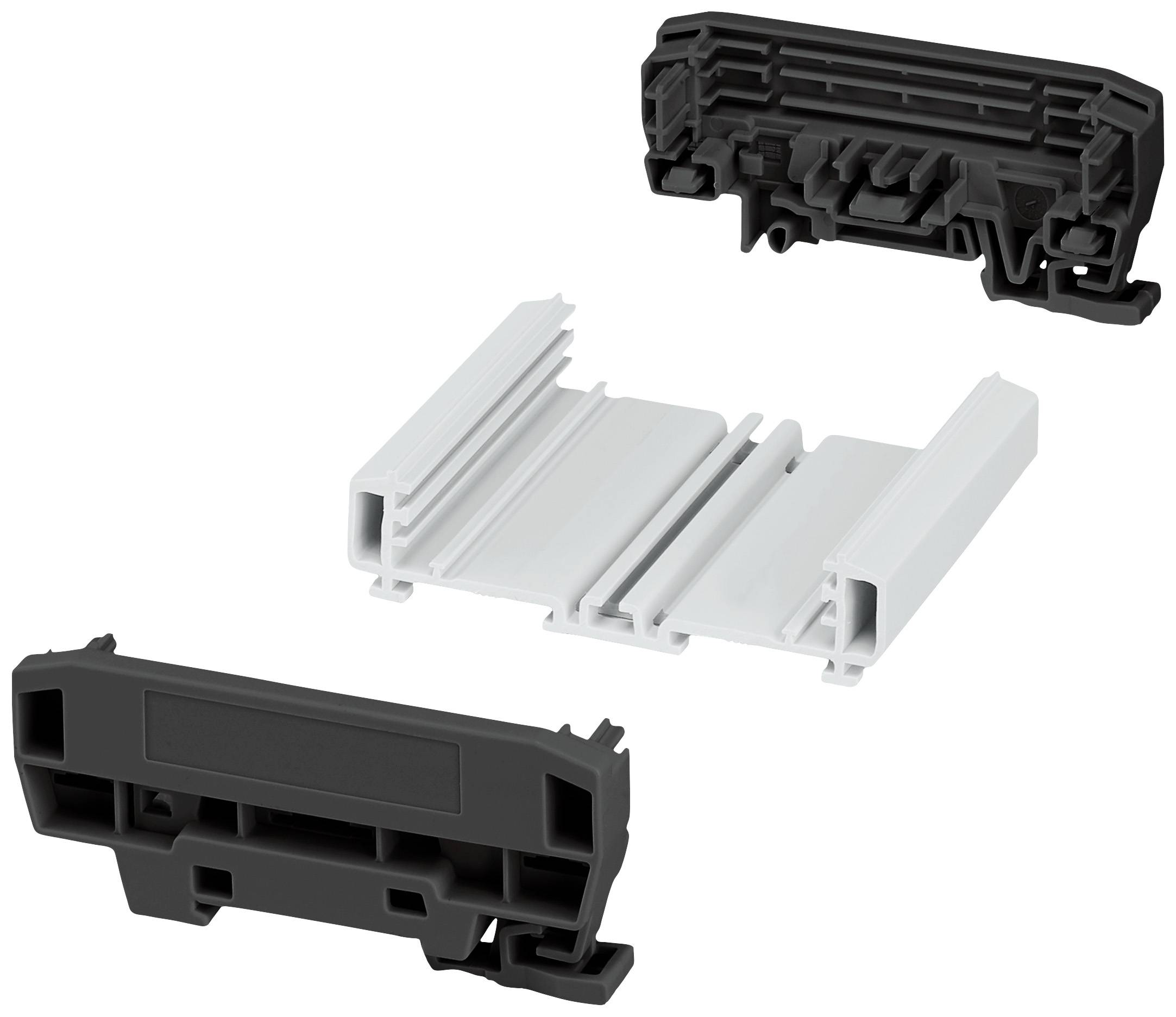 Drei Kunststoffteile in Schwarz und Weiß, die zusammen einen Montagerahmen bilden. Sie scheinen für einen elektrischen Anschluss konzipiert zu sein.