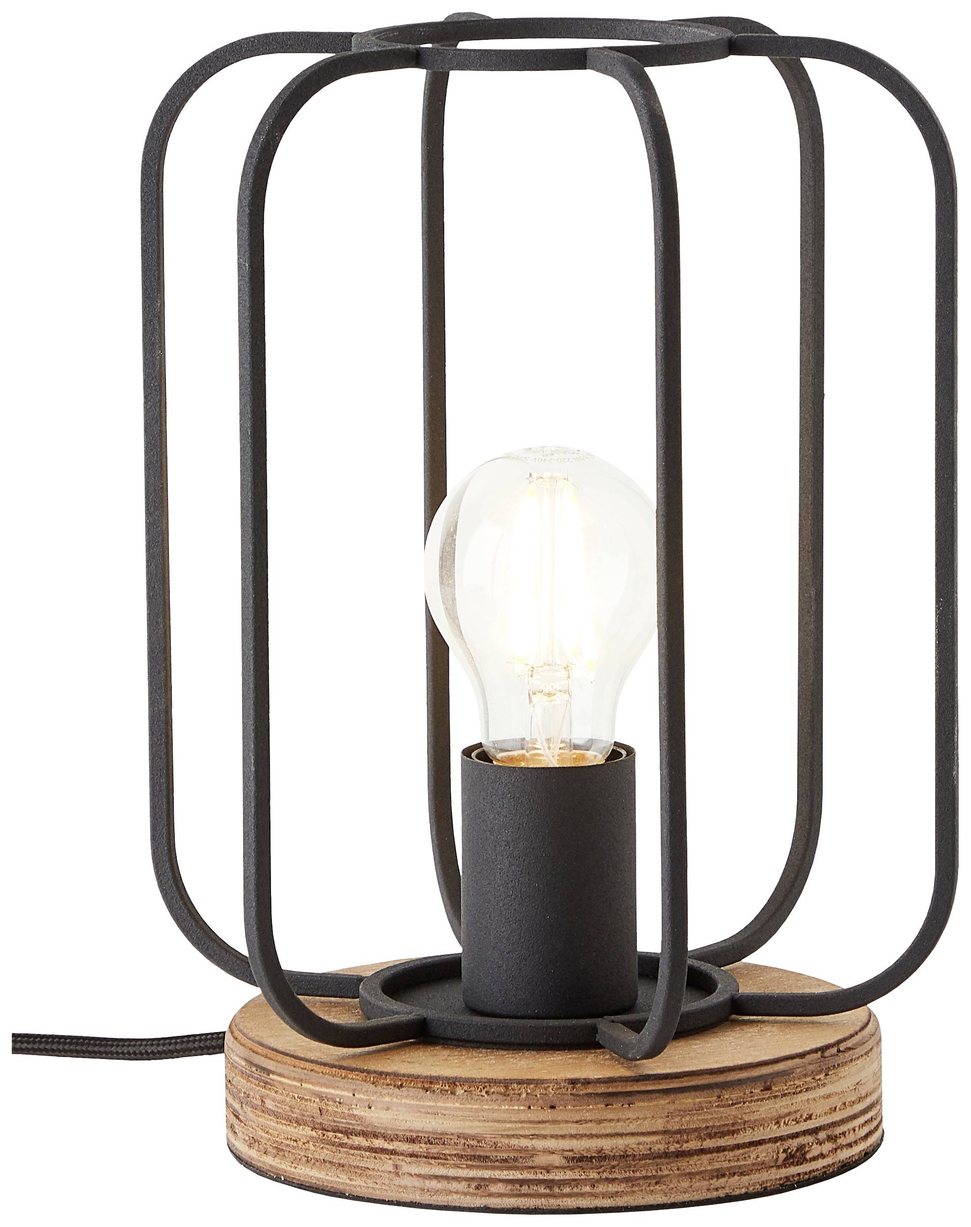 Eine Tischlampe mit einem rustikalen Holzsockel und einem schwarzen Metallgitter, das eine sichtbare Glühbirne umgibt.