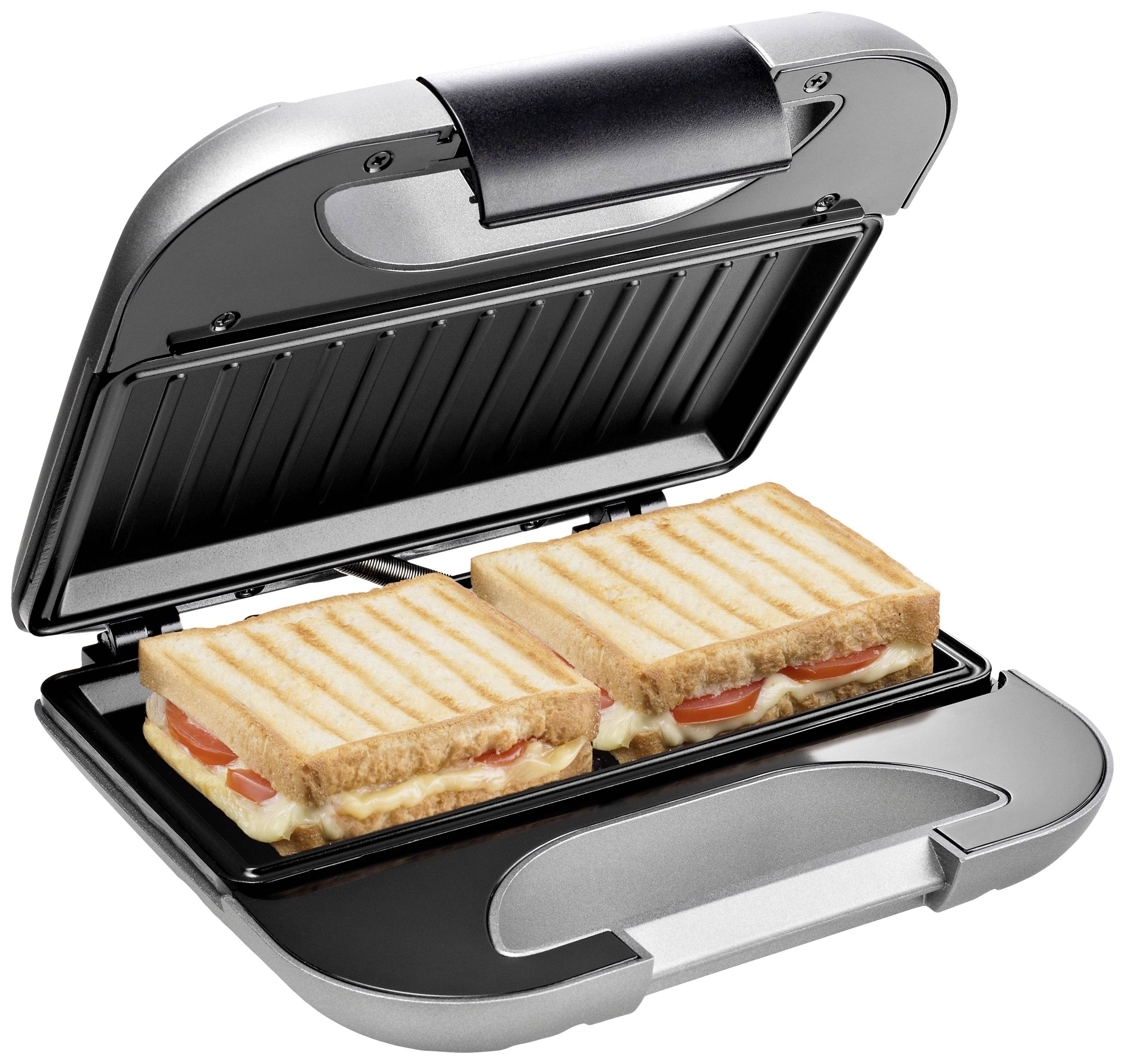 Ein Sandwichmaker grillt zwei belegte Toasts mit Tomaten und Käse. Der Maker ist offen, die Toasts haben Grillstreifen.