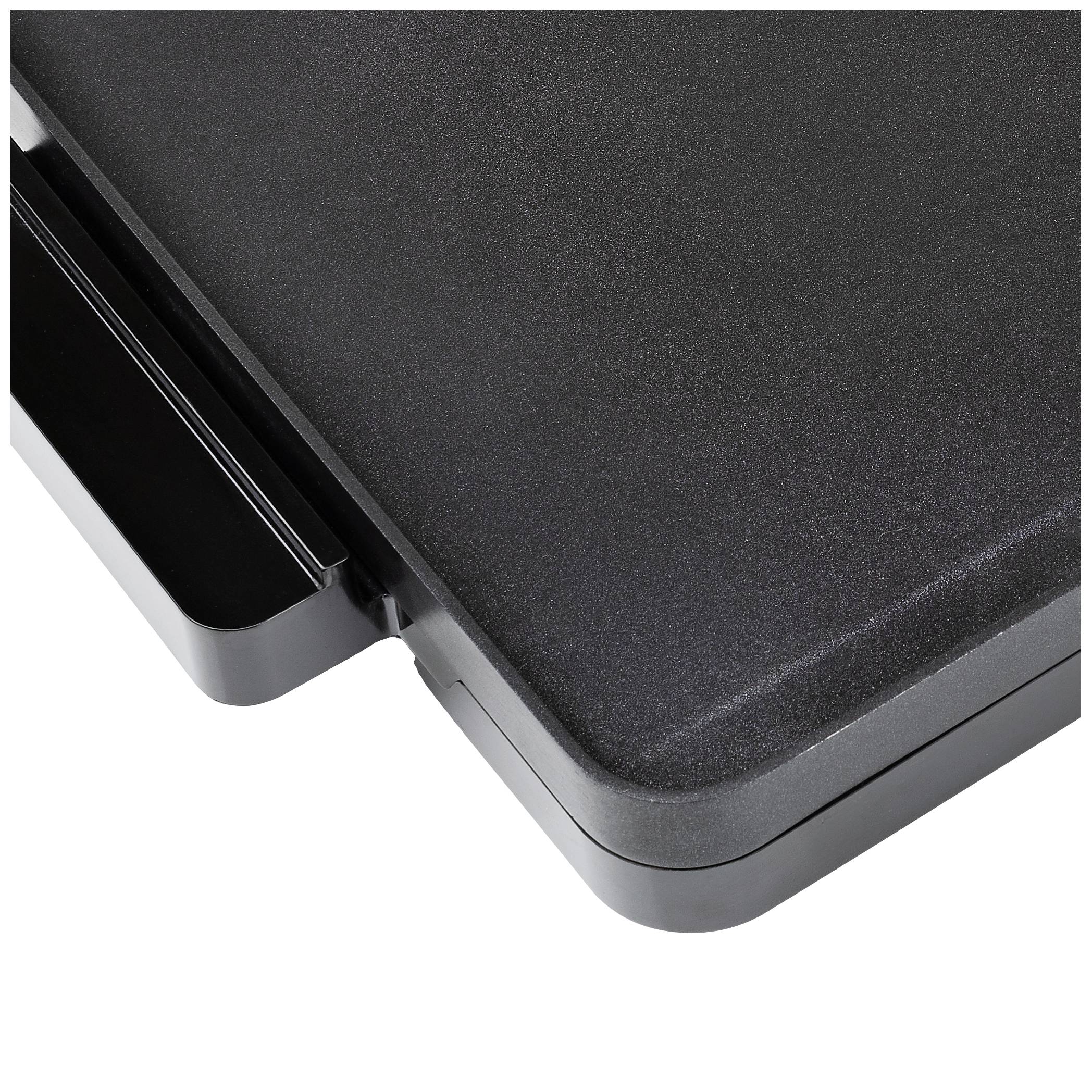 Schwarze Kante eines flachen, rechteckigen Objekts, möglicherweise ein Tisch oder eine Arbeitsfläche, mit abgerundeten Ecken.