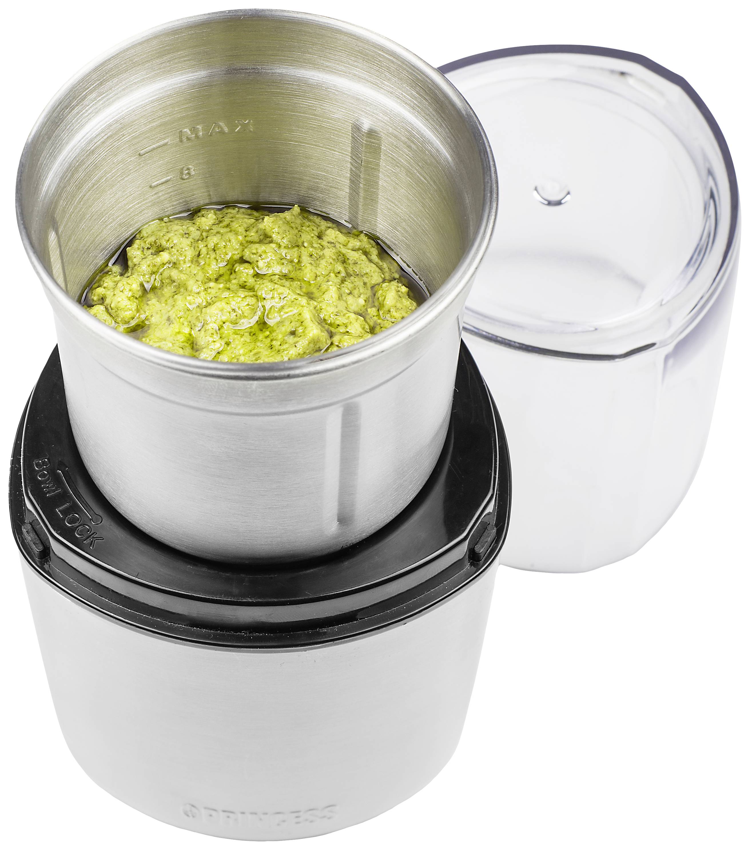 Kaffeemühle in silberner Farbe mit geöffnetem Deckel, gefüllt mit gemahlenem Kaffee.