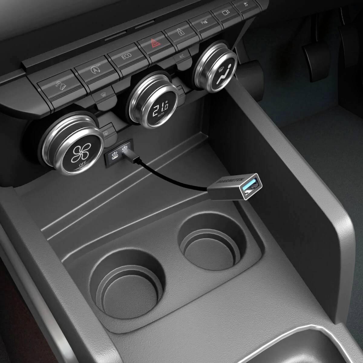Mittelkonsole eines Autos mit runden Belüftungsdüsen, einem USB-Anschluss und einem eingesteckten USB-Kabel.