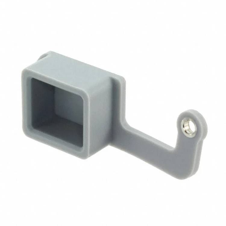 Ein graues, rechteckiges Kunststoffteil mit einem vorstehenden Arm und einem kleinen kreisförmigen Loch am Ende des Arms.