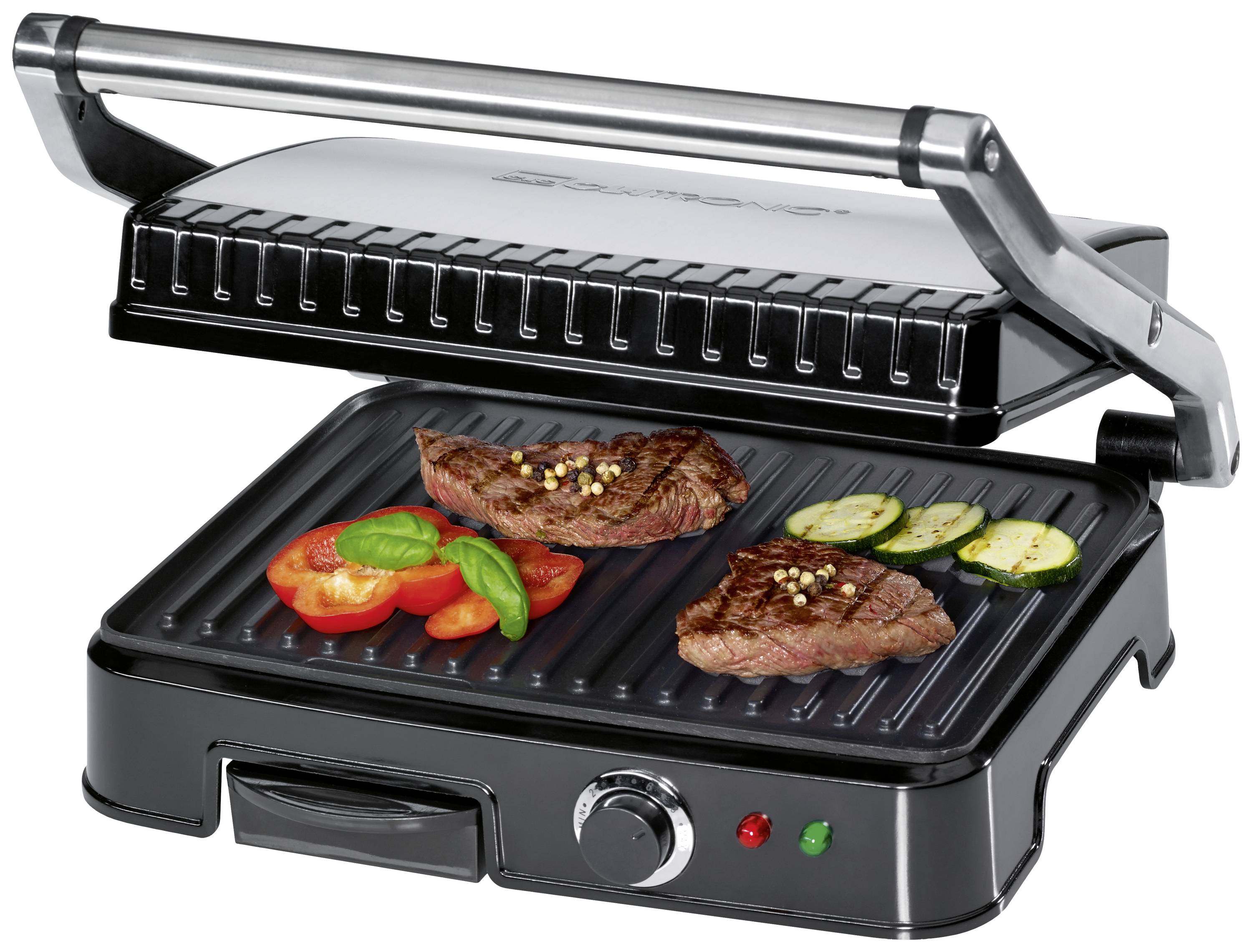Offener Kontaktgrill mit gegrillten Steaks, Tomaten, Zucchini und Basilikum auf den Grillplatten. Drehknopf und Leuchten an der Vorderseite.