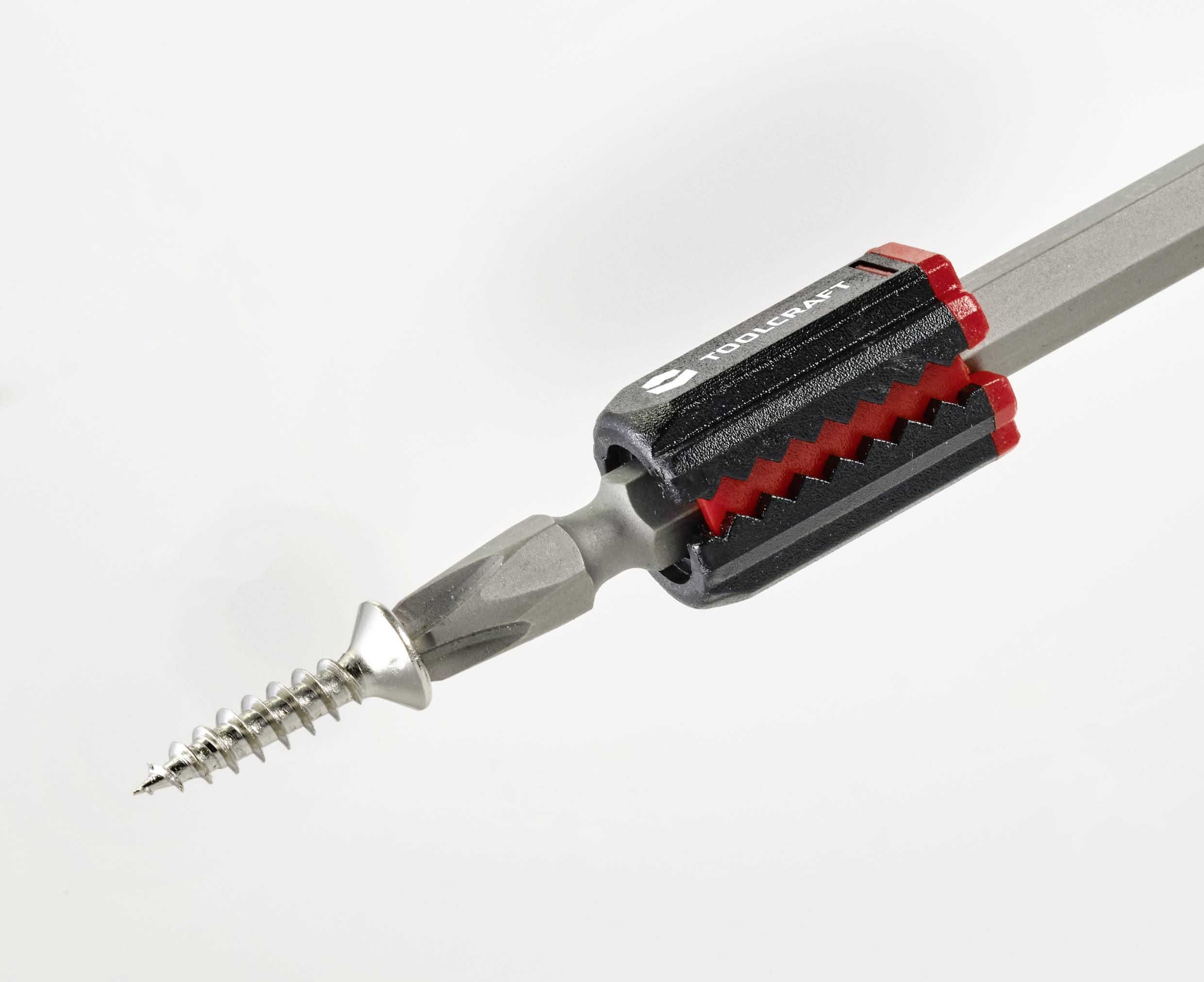 Nahaufnahme eines Schraubendrehers mit eingesetzter Schraube, montiert in einem magnetischen Bithalter mit grauem Griff und roten Akzenten.