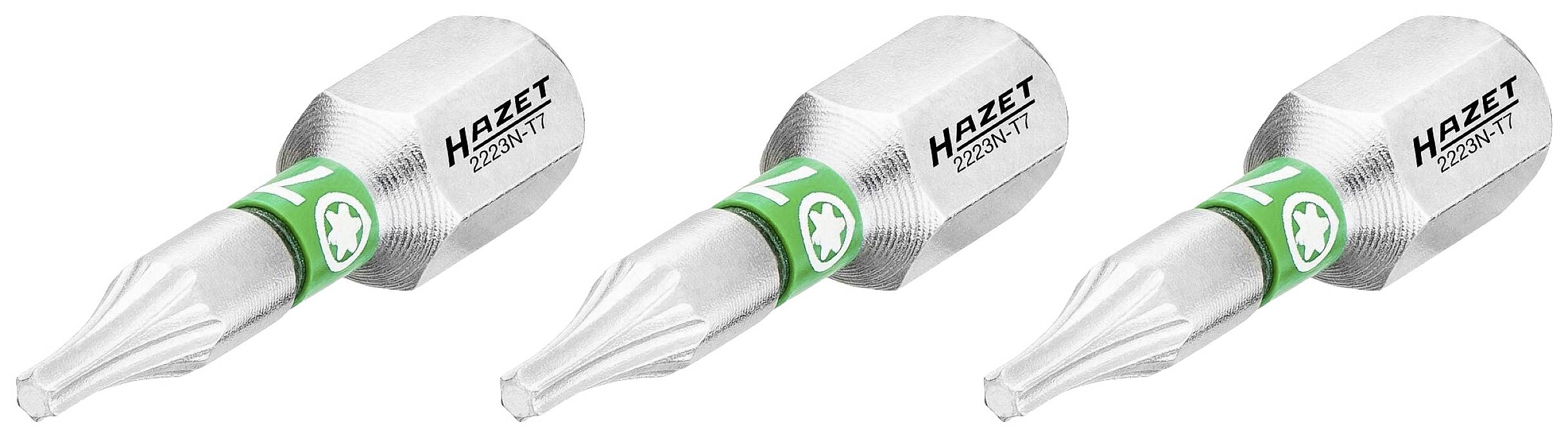 Drei metallische Schraubendrehereinsätze von Hazet, jede mit grünem Ring und einer Torx-Spitze, nebeneinander aufgereiht.