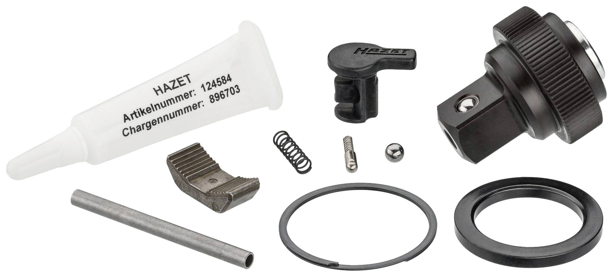 Ein Reparatursatz mit mehreren Komponenten: Tube, Schraubenschlüsselteil, Federn, Metallstifte und Ringe, neben einem Hauptadapter.