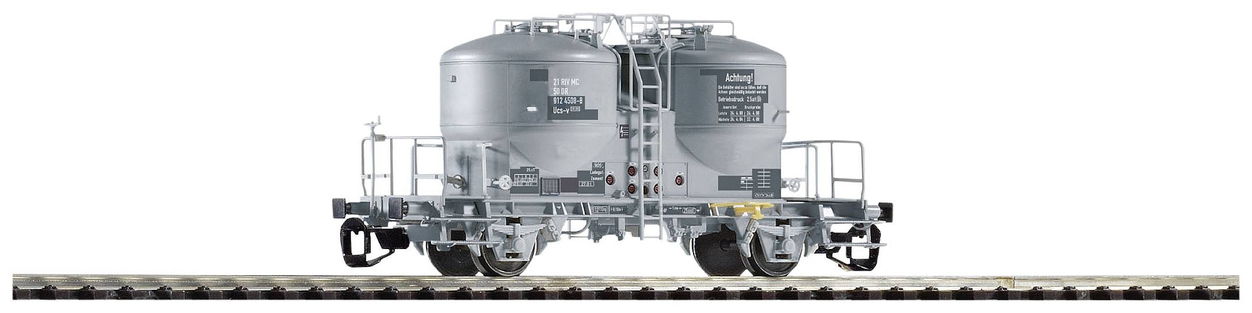 Grau lackierter Eisenbahn-Kesselwagen auf Gleis, seitliche Ansicht. Der Wagen hat zwei große Tanks und zahlreiche Beschriftungen.