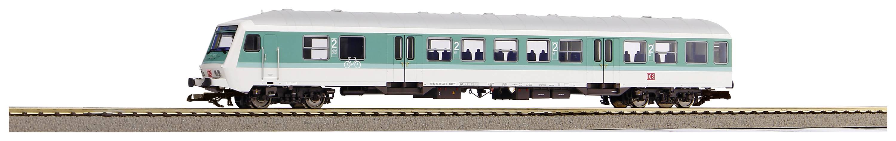 Ein einzelner weiß-grüner Modellzugwaggon steht auf einem Gleis.