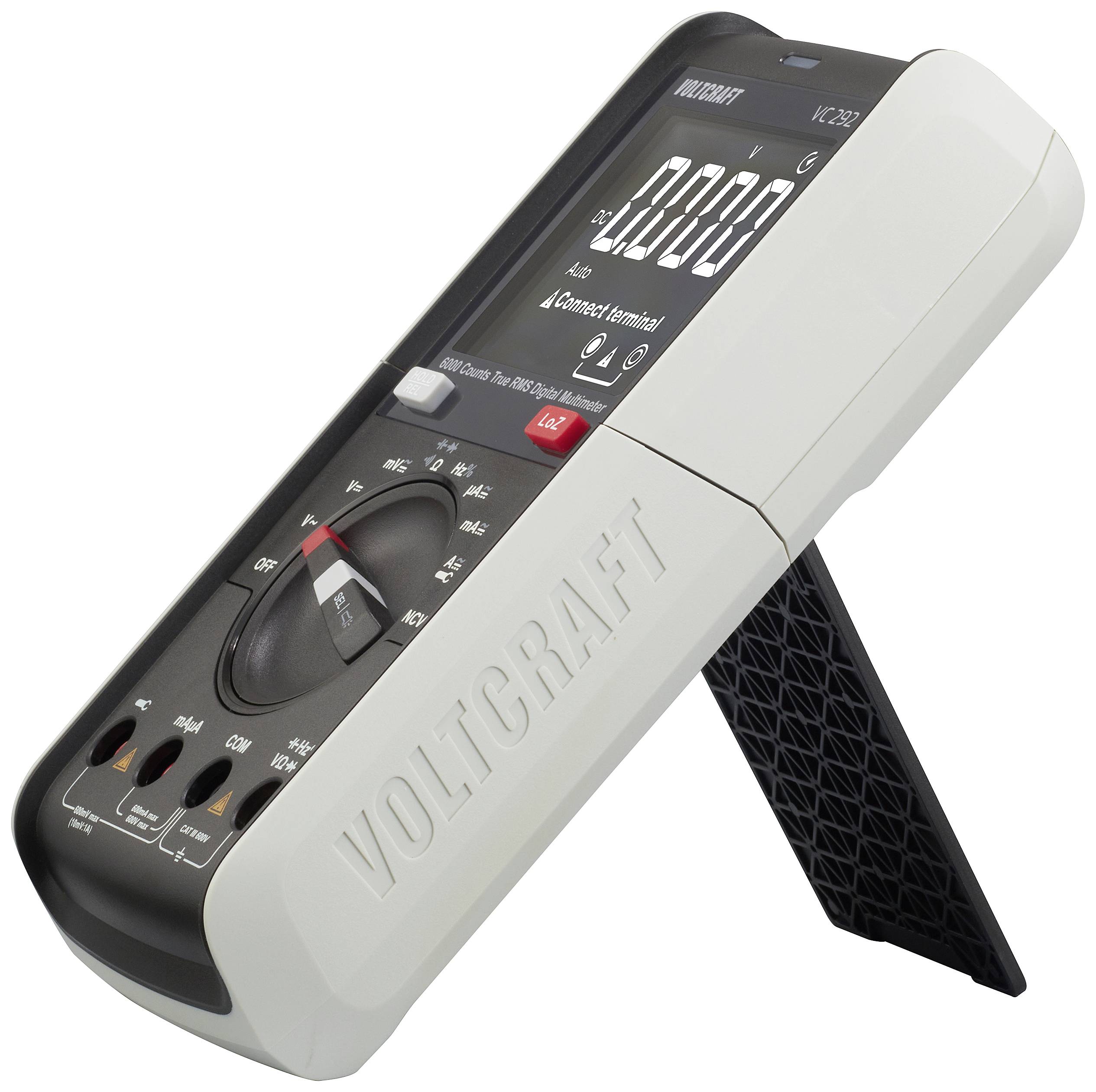 Ein digitales Multimeter mit Ständer, zeigt eine Nullanzeige. Markenname 'Voltcraft' sichtbar auf dem Gehäuse.