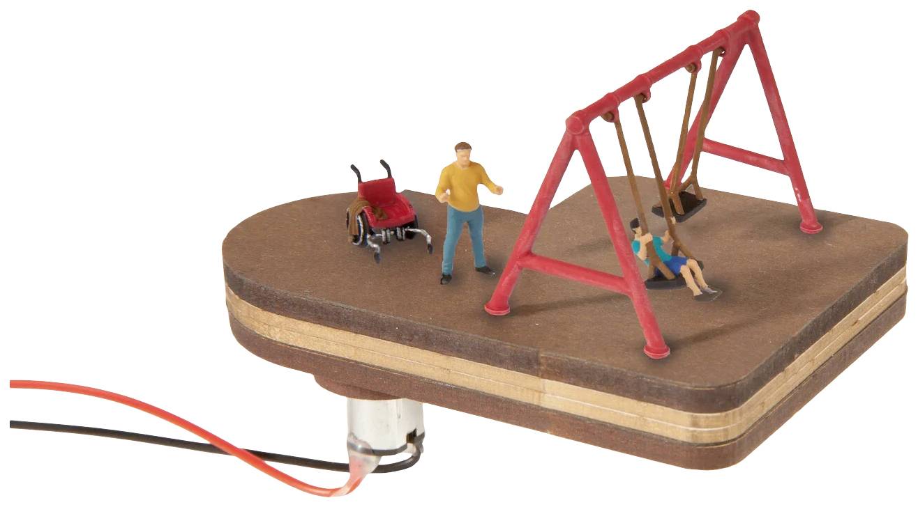 Ein mechanisches Modell zeigt eine Szene mit zwei Figuren: eine Person schaukelt, die andere steht daneben, mit einem Rollstuhl in der Nähe.