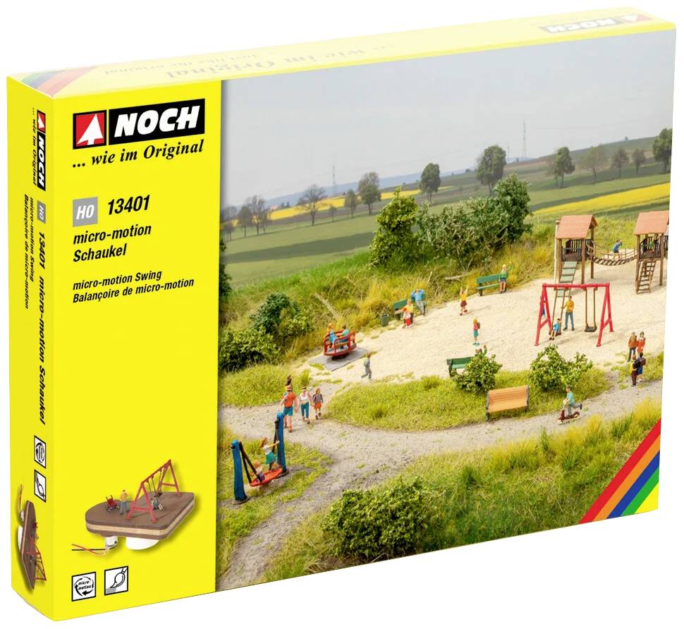 Verpackung einer Modellbahnzubehör-Schaukel in H0-Maßstab. Zeigt eine Miniaturlandschaft mit Menschen, Bäumen und Spielplatz.