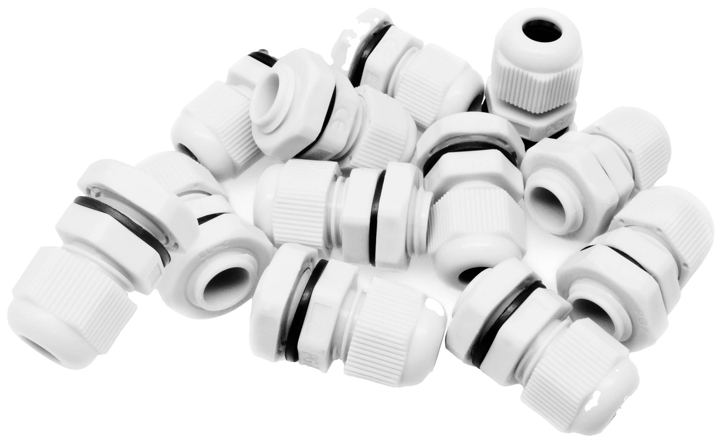 Mehrere weiße Kabelverschraubungen liegen lose verteilt. Sie sind zylindrisch geformt und haben schwarze Dichtungsringe.