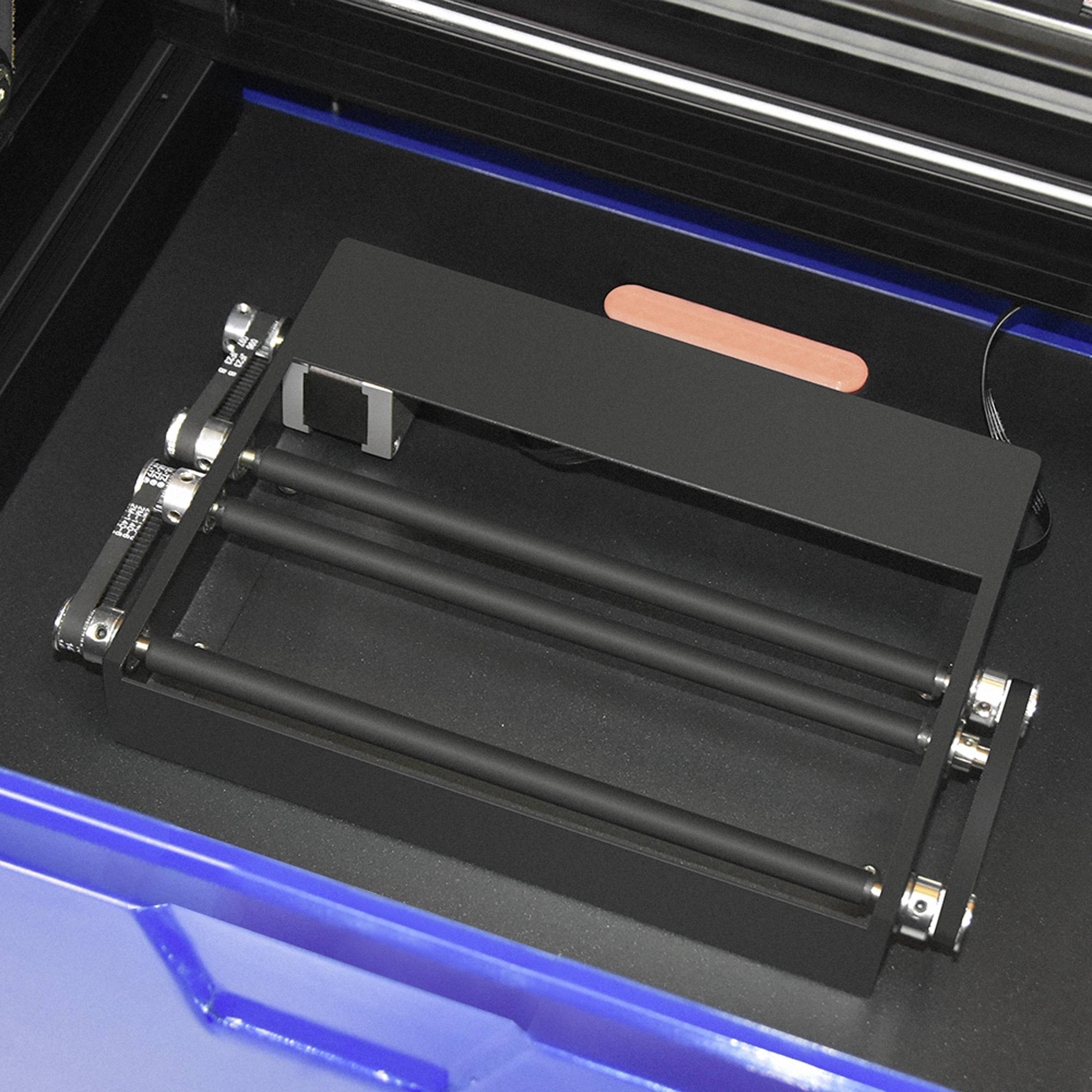 Ein offener 3D-Drucker mit sichtbaren Rollen und einer Plattform zur Materialzufuhr.