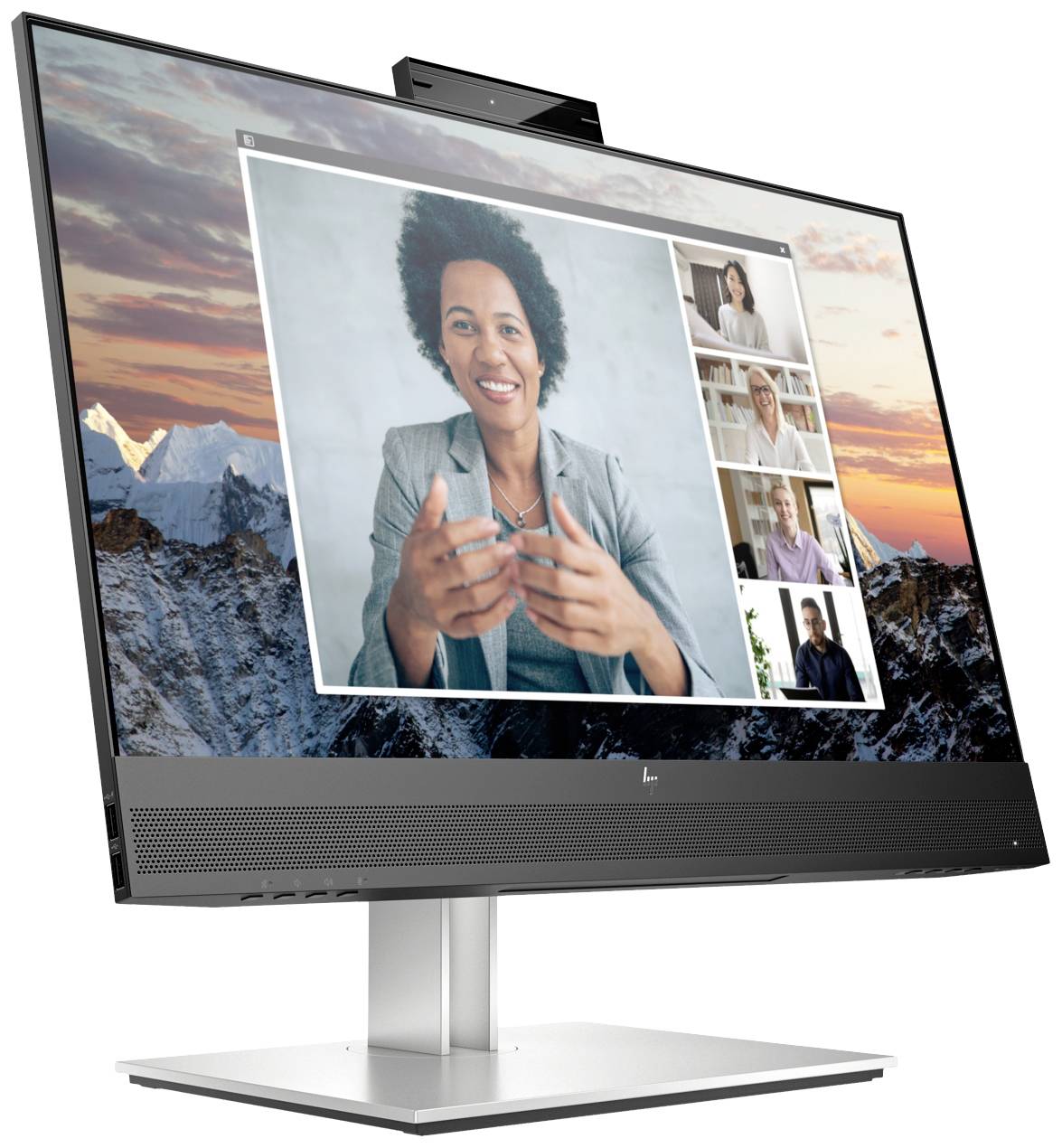 Ein Computerbildschirm zeigt eine Videokonferenz mit fünf Personen. Im Hintergrund sind schneebedeckte Berge bei Sonnenuntergang zu sehen.