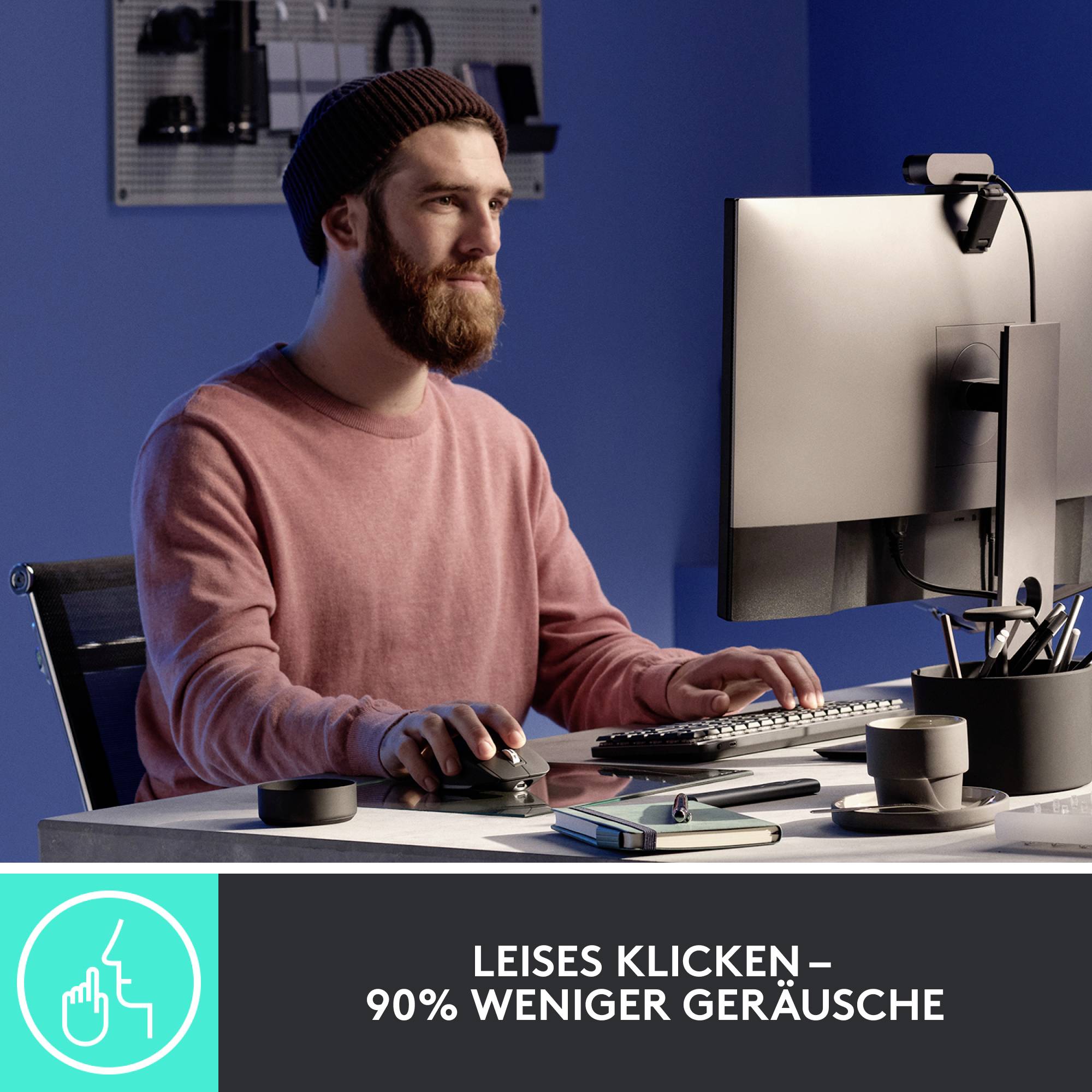 Ein Mann arbeitet konzentriert an einem Computer in einem modernen Büro. Text: 'Leises Klicken – 90% weniger Geräusche'.