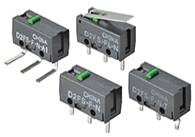 Vier kleine Mikroschalter in schwarzem Gehäuse, einer mit Hebel. Sie sind für elektronische Anwendungen gestaltet.