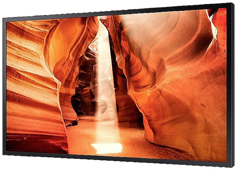 Lichtstrahl fällt in einen engen, orangefarbenen Canyon, der durch glatte, gewundene Felswände geformt ist.