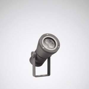 Ein graues, zylinderförmiges Außenstrahler-Licht, das zur Akzentuierung von Fassaden oder Gärten verwendet wird, vor einem neutralen Hintergrund.