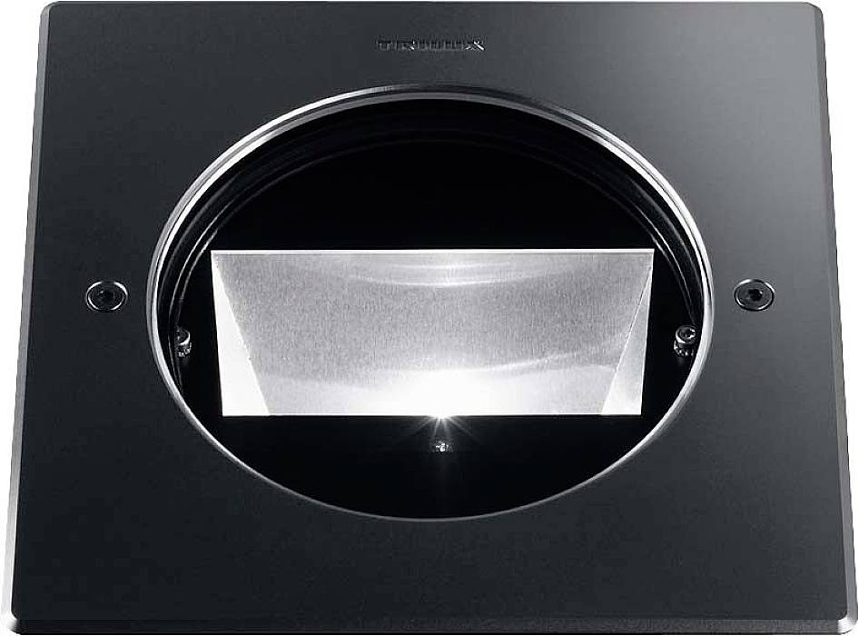 Ein schwarzer rechteckiger Rahmen mit rundem Ausschnitt zeigt eine innenliegende, glänzende Linse oder Reflektorstruktur.