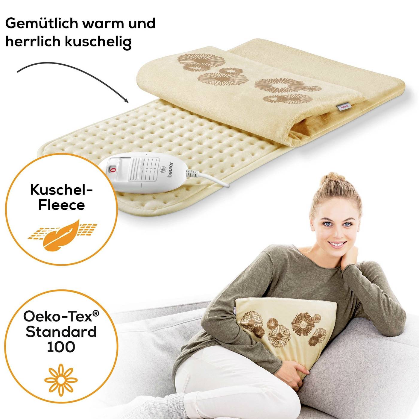 Eine Frau umarmt ein beheiztes Kissen mit Blumenmuster. Text: 'Gemütlich warm und herrlich kuschelig', 'Oeko-Tex Standard 100'.