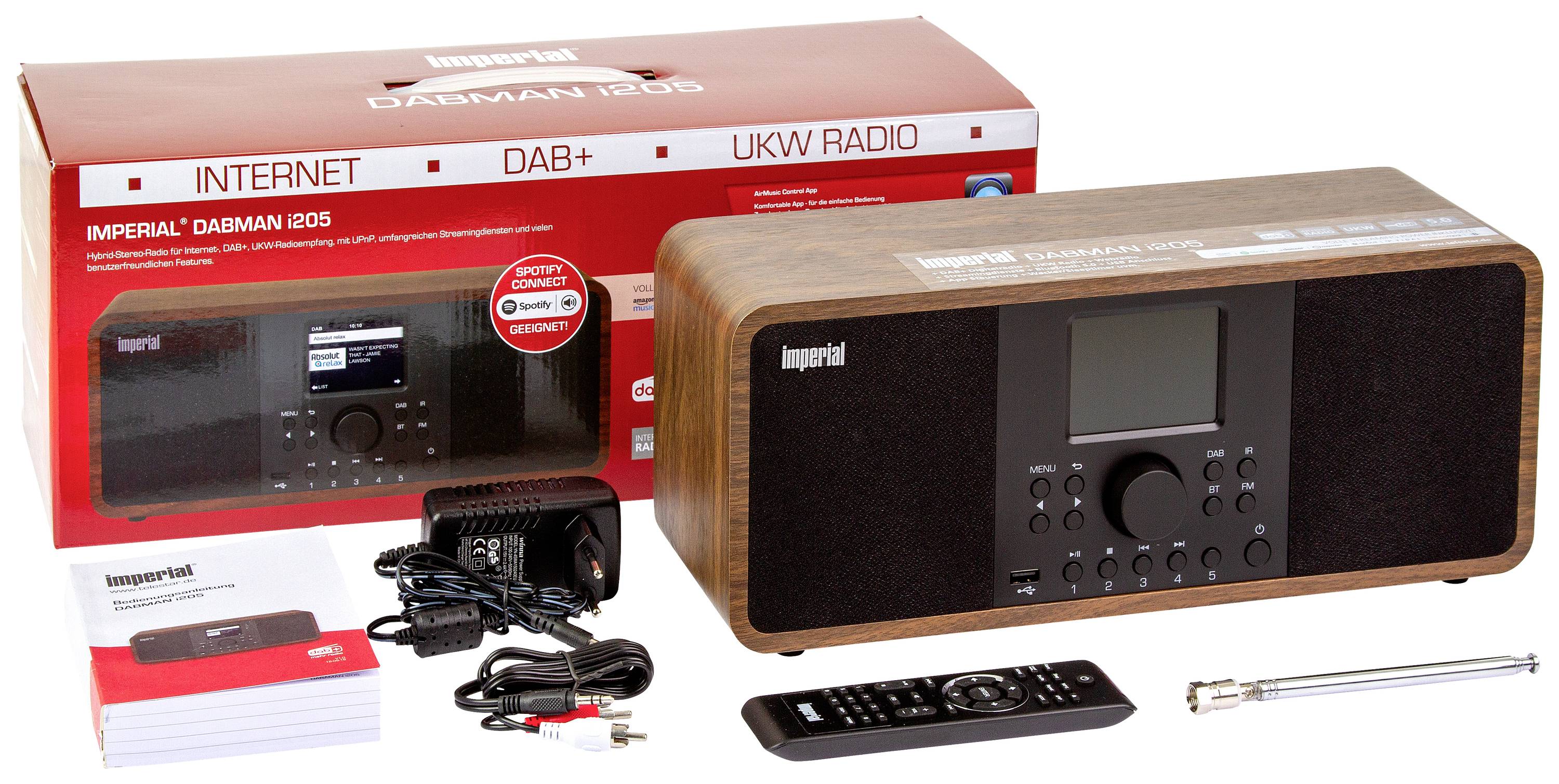 Radio mit Holzkorpus und Bildschirm, Fernbedienung, Antenne und Netzkabel. Verpackung mit Aufschrift 'INTERNET DAB+ UKW RADIO'.