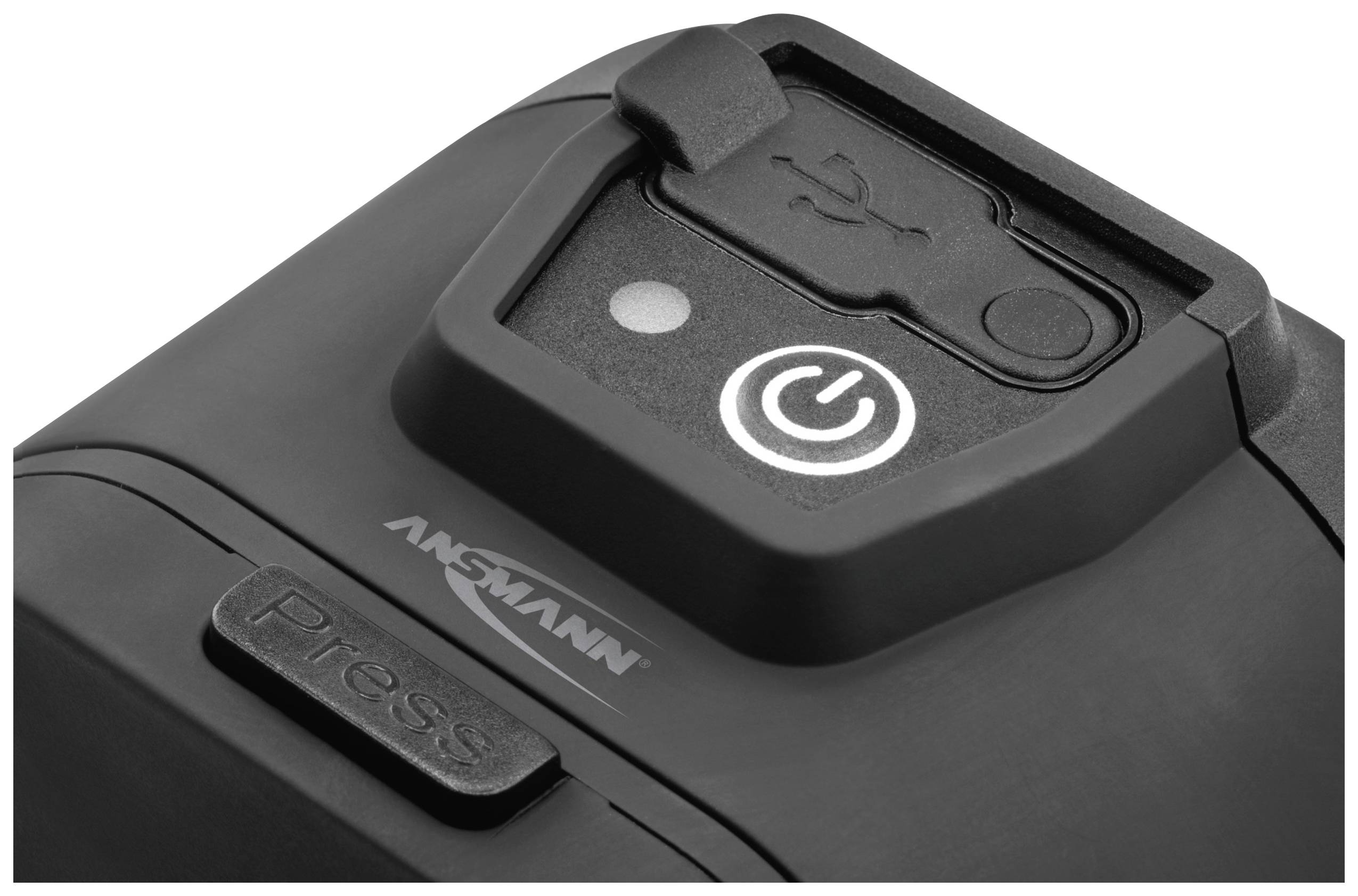 Schwarze elektrisches Gerät mit USB-Anschluss und Ein-/Aus-Taste. Markenname 'Ansmann' und Schriftzug 'Press'.