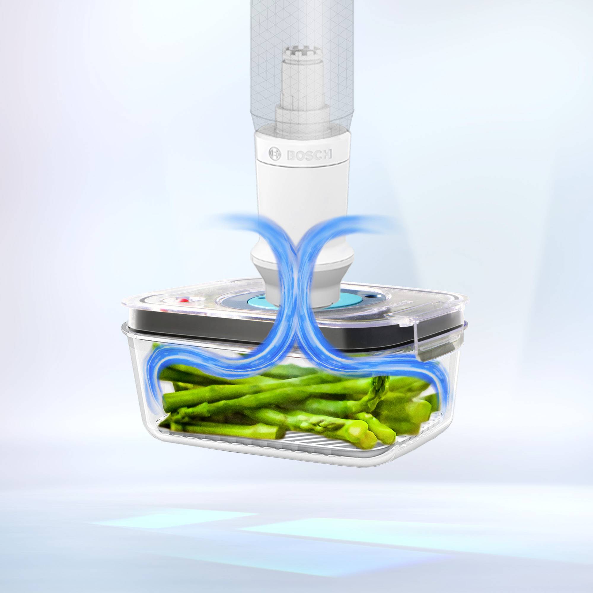 Vakuumierer versiegelt eine Box mit grünen Spargelstangen. Luftstrom zeigt Vakuumprozess.