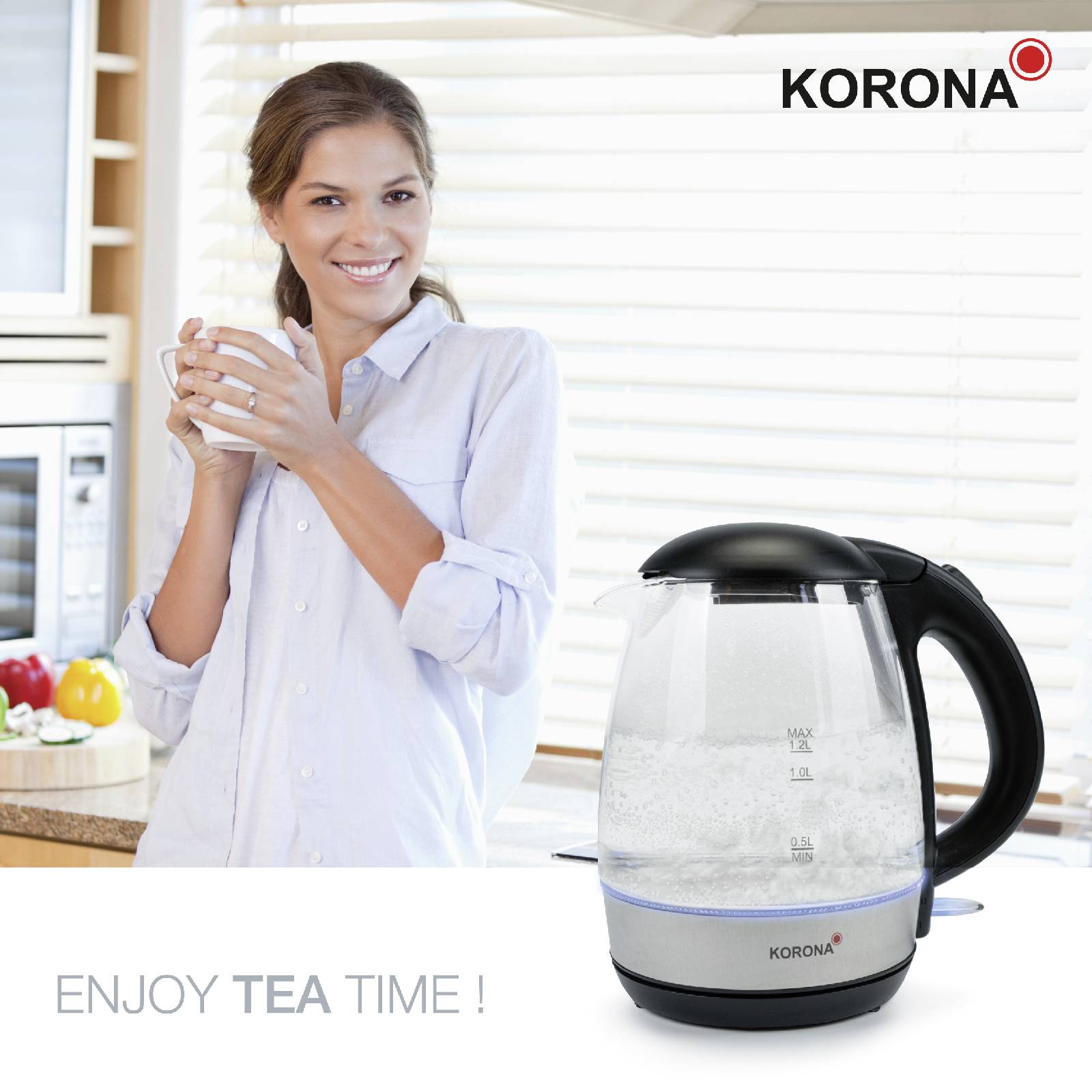 Frau lächelt in Küche mit einem Glas; Wasserkocher der Marke 'Korona' daneben. Text: 'ENJOY TEA TIME!'.