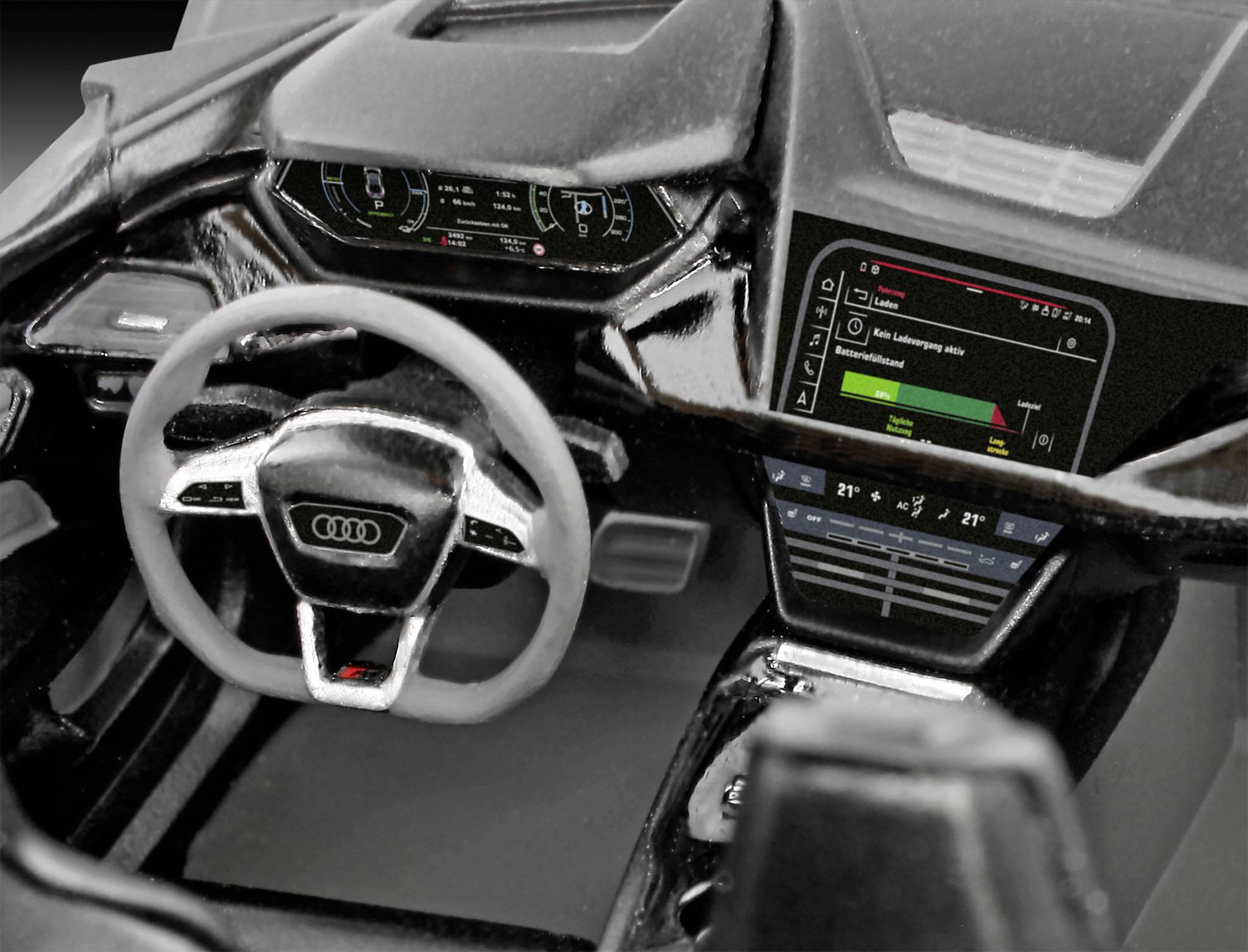 Das Bild zeigt das Innenleben eines Audi-Autos mit Lenkrad und digitalen Displayanzeigen. Verschiedene Tasten und Anzeigen sind sichtbar.