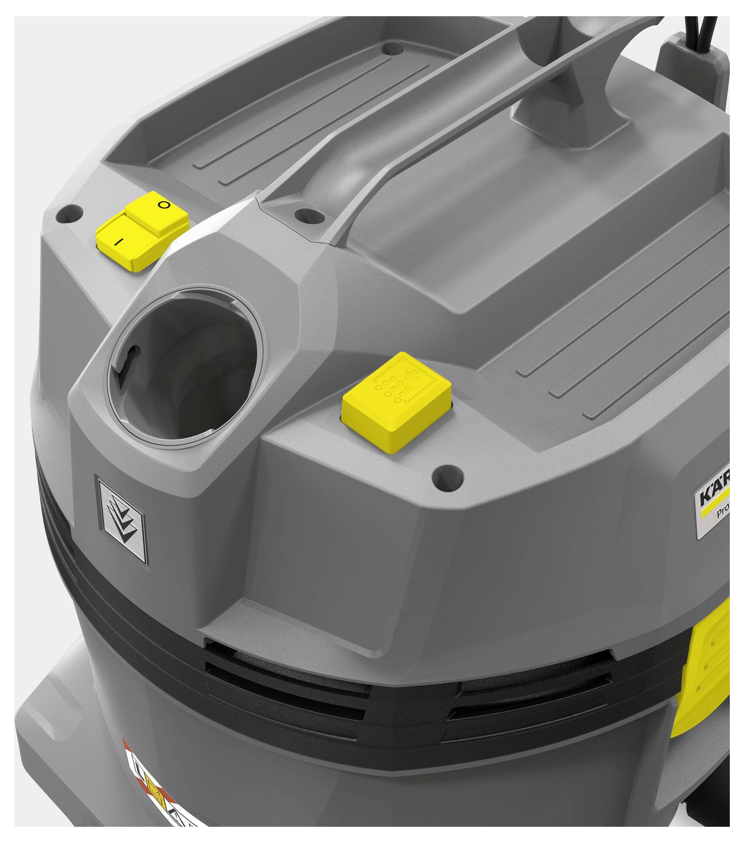 Ein grauer industrieller Staubsauger mit einem gelben Einschaltknopf und einem großen Griff oben. Die Maschine hat ein robustes, eckiges Design.