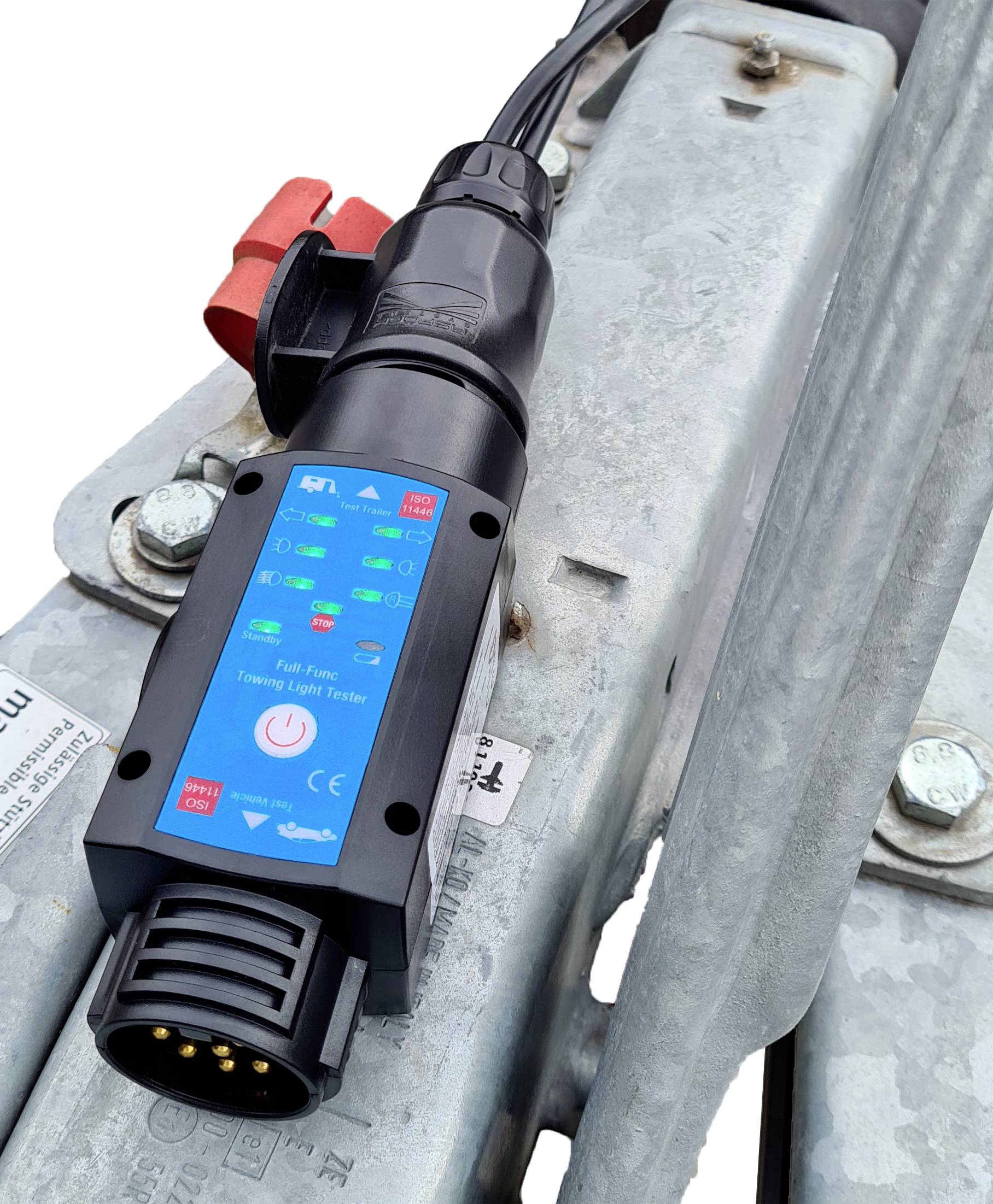 Ein elektrischer Ladestecker mit leuchtenden Kontrollleuchten ist auf einem metallischen Untergrund montiert.