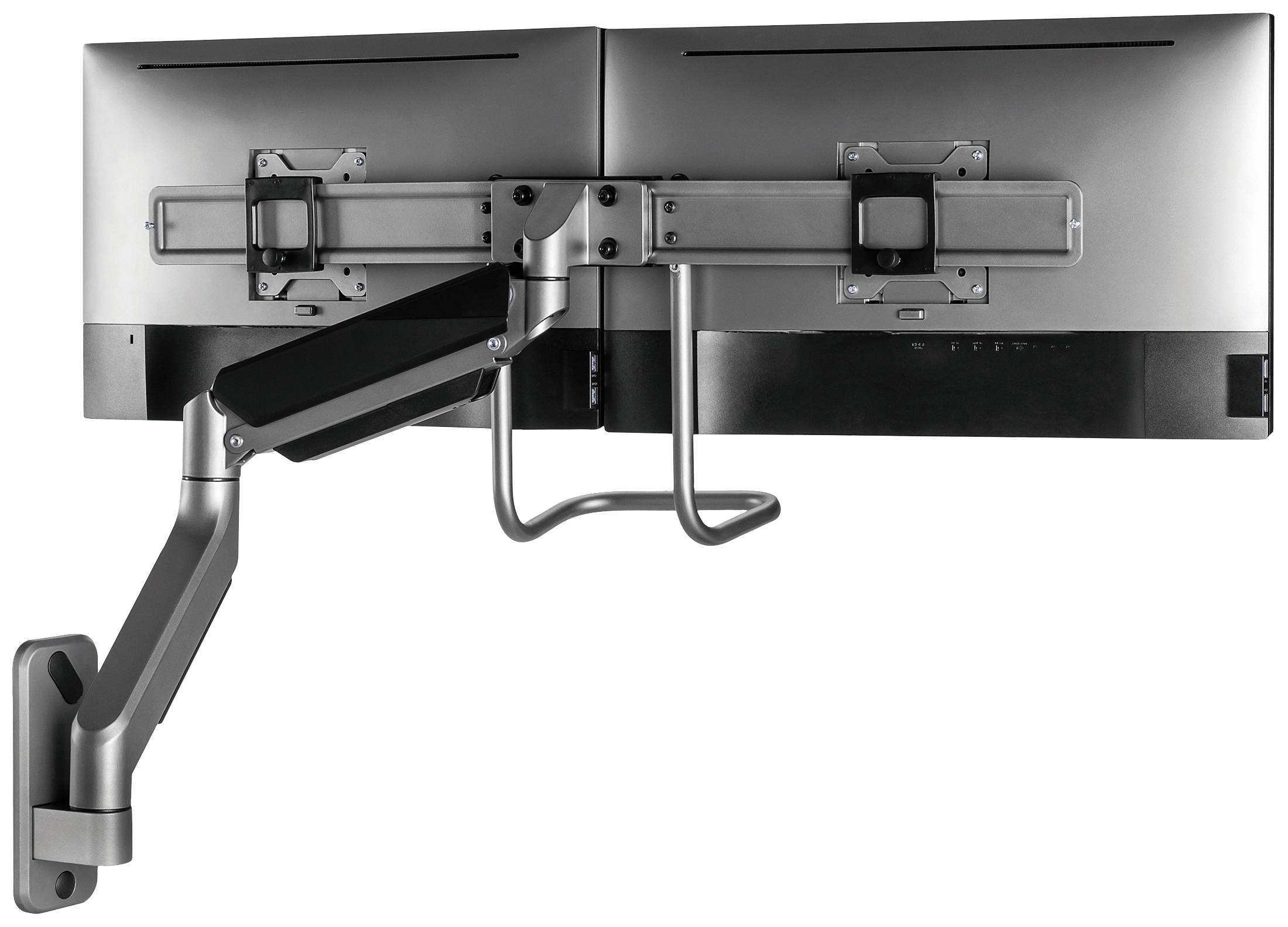 Ein dualer Monitorarm ist an der Wand montiert. Er hält zwei Monitore nebeneinander und ermöglicht eine flexible Positionierung.