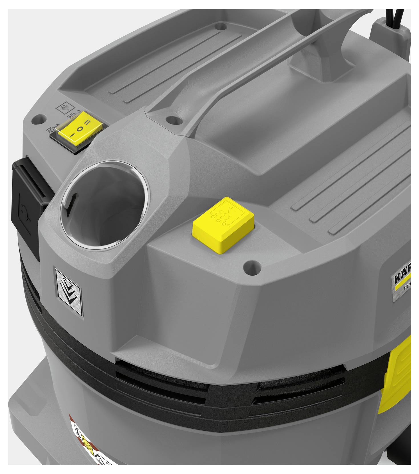 Eine Nahaufnahme eines grauen industriellen Staubsaugers mit einem Griff, zwei gelben Knöpfen und einer kreisförmigen Öffnung auf seiner Oberseite.