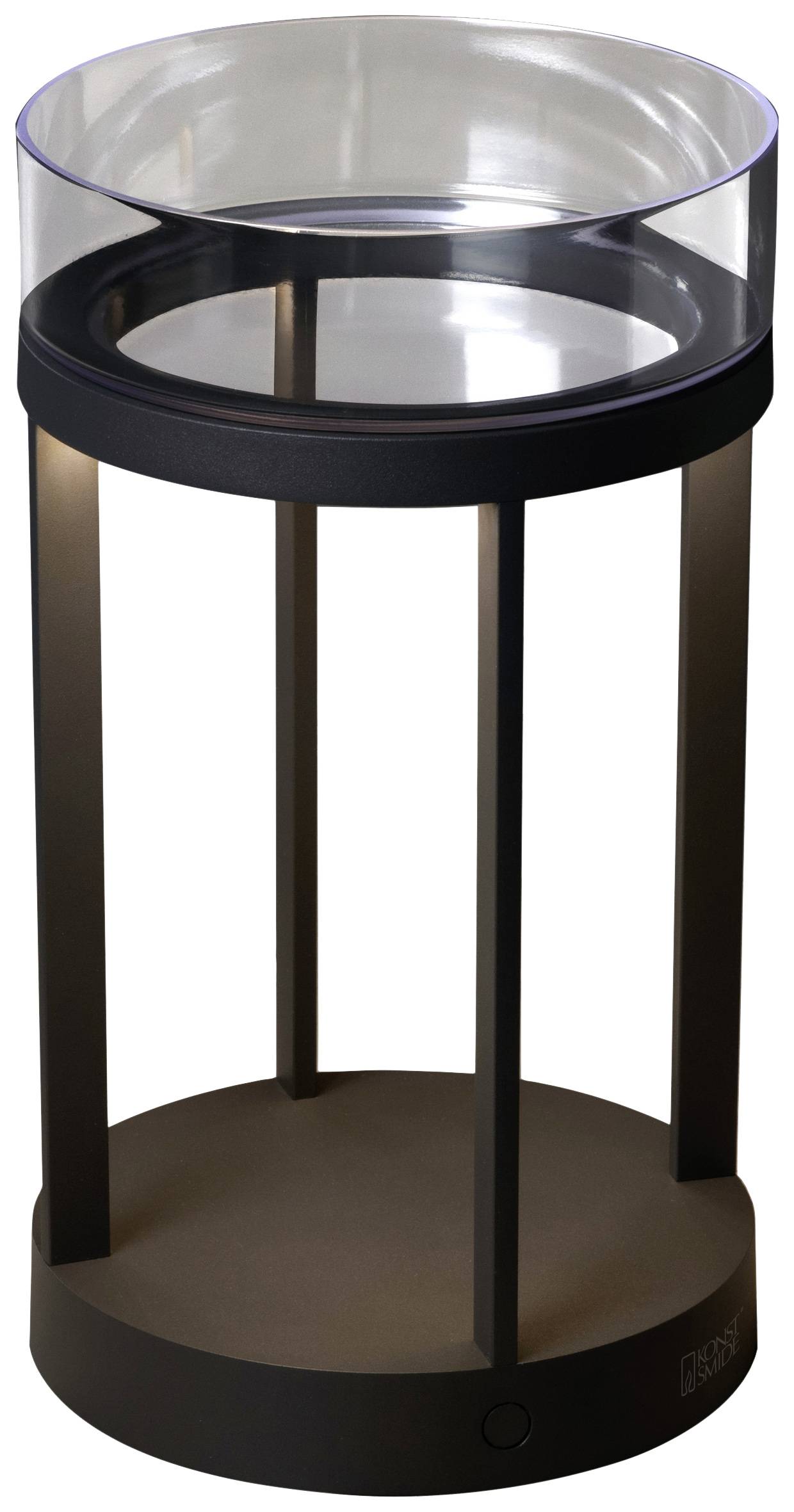 Eine schwarze, zylindrische Tischlampe mit einem klaren Glasring oben, auf einem schwarzen Sockel stehend.