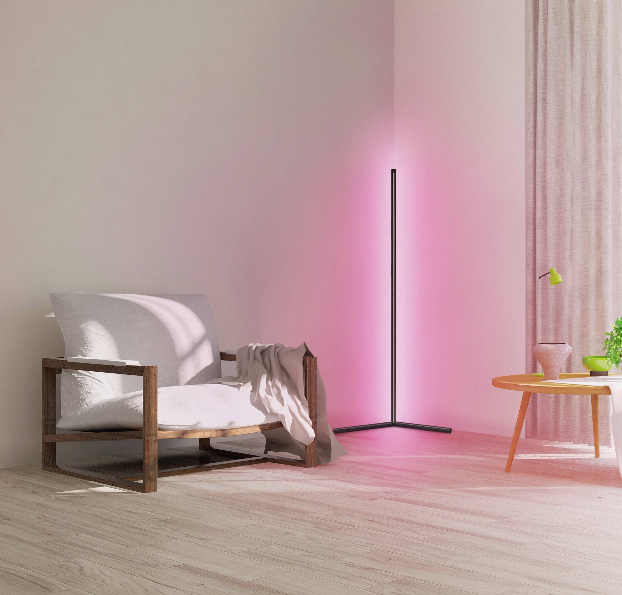 Ein modernes Wohnzimmer mit einem beigen Sessel, einer Stehlampe in der Ecke und einem runden Tisch mit Pflanze und Vase am Fenster.